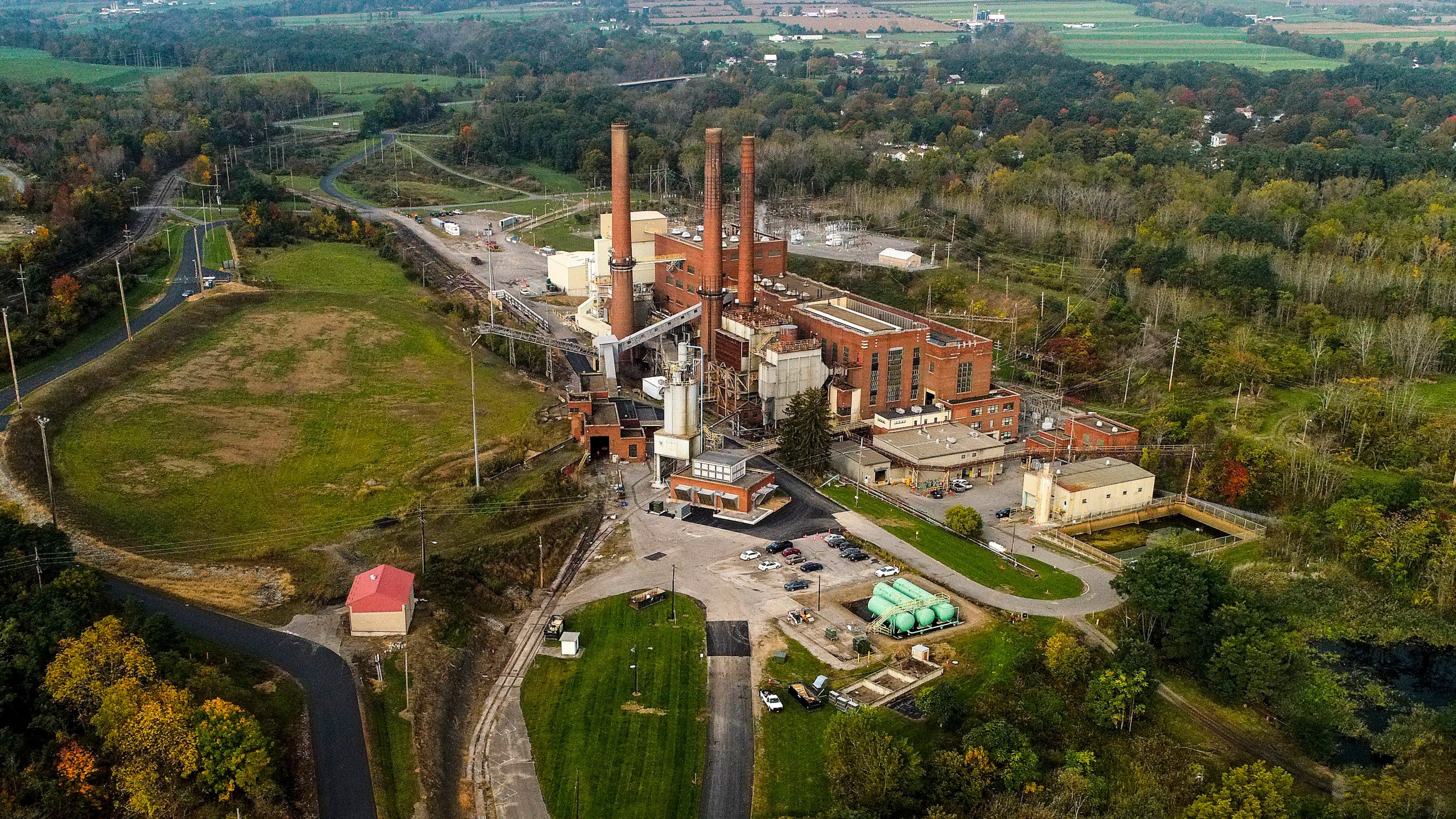 FILE - A brief patch of early morning sunlight brightens the landscape around the Greenidge Generation power plant, Oct. 15, 2021, in Dresden, N.Y. (AP Photo/Julie Jacobson, File)