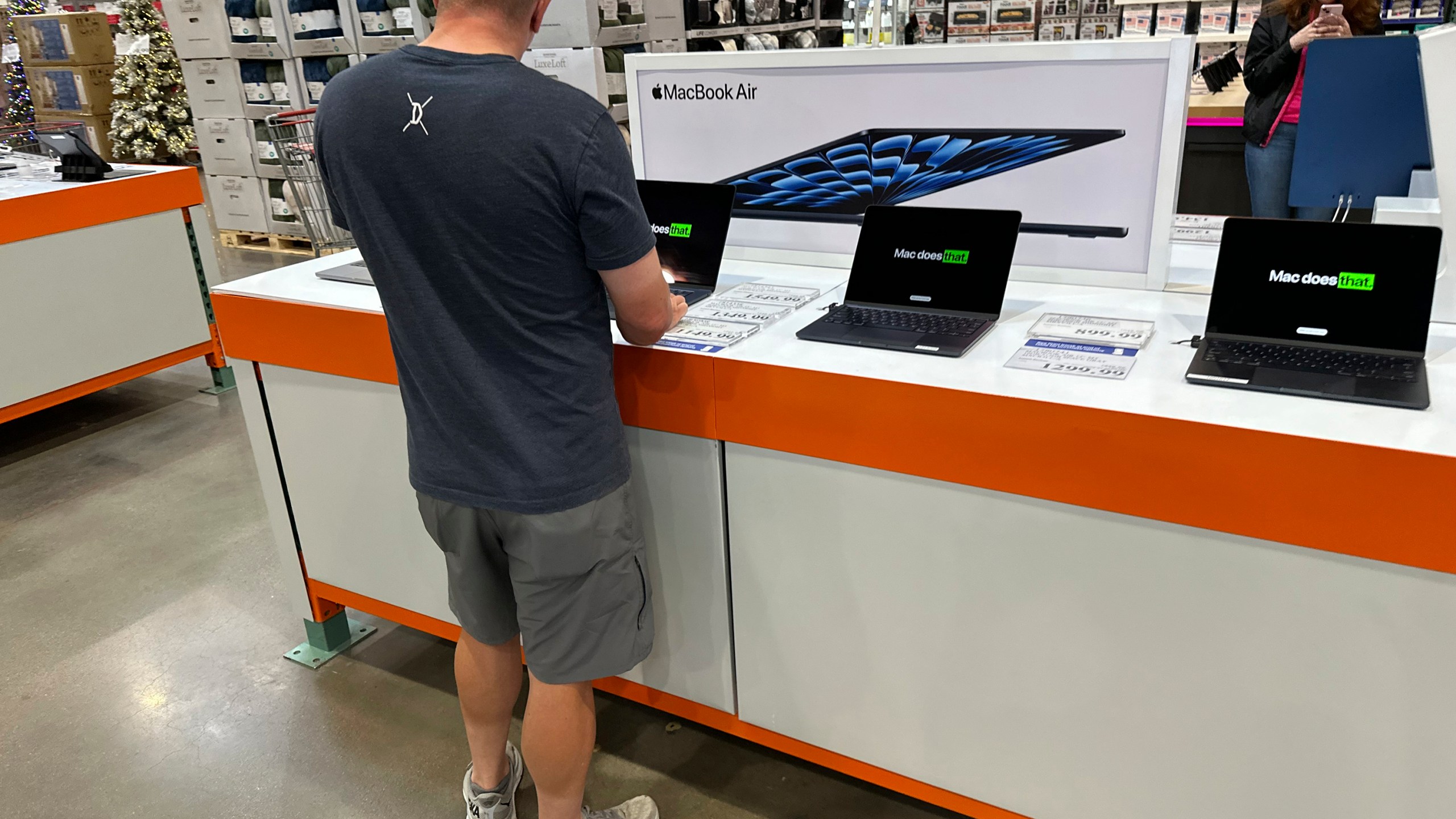 FILE - A shopper considers a MacBook Air on display in a Costco warehouse on Sept. 19, 2024, in Lone Tree, Colo. (AP Photo/David Zalubowski, File)