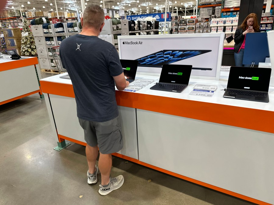 FILE - A shopper considers a MacBook Air on display in a Costco warehouse on Sept. 19, 2024, in Lone Tree, Colo. (AP Photo/David Zalubowski, File)