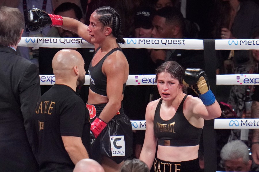 Amanda Serrano, left, and Katie Taylor react after their undisputed super lightweight title bout, Friday, Nov. 15, 2024, in Arlington, Texas. (AP Photo/Julio Cortez)