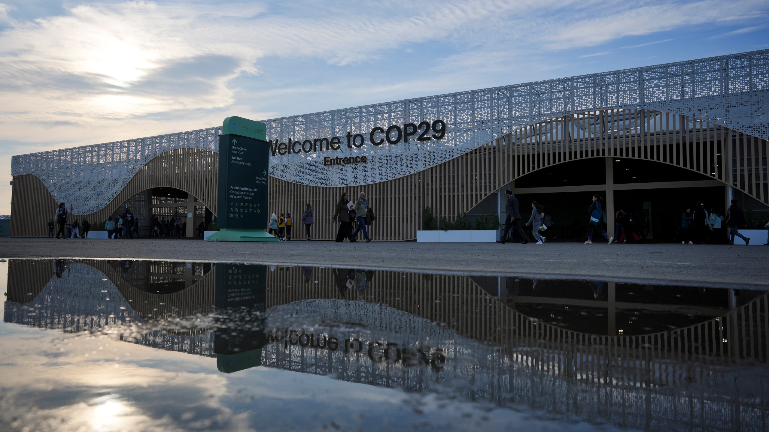 People arrive for the day outside the venue for the COP29 U.N. Climate Summit, Saturday, Nov. 16, 2024, in Baku, Azerbaijan. (AP Photo/Peter Dejong)