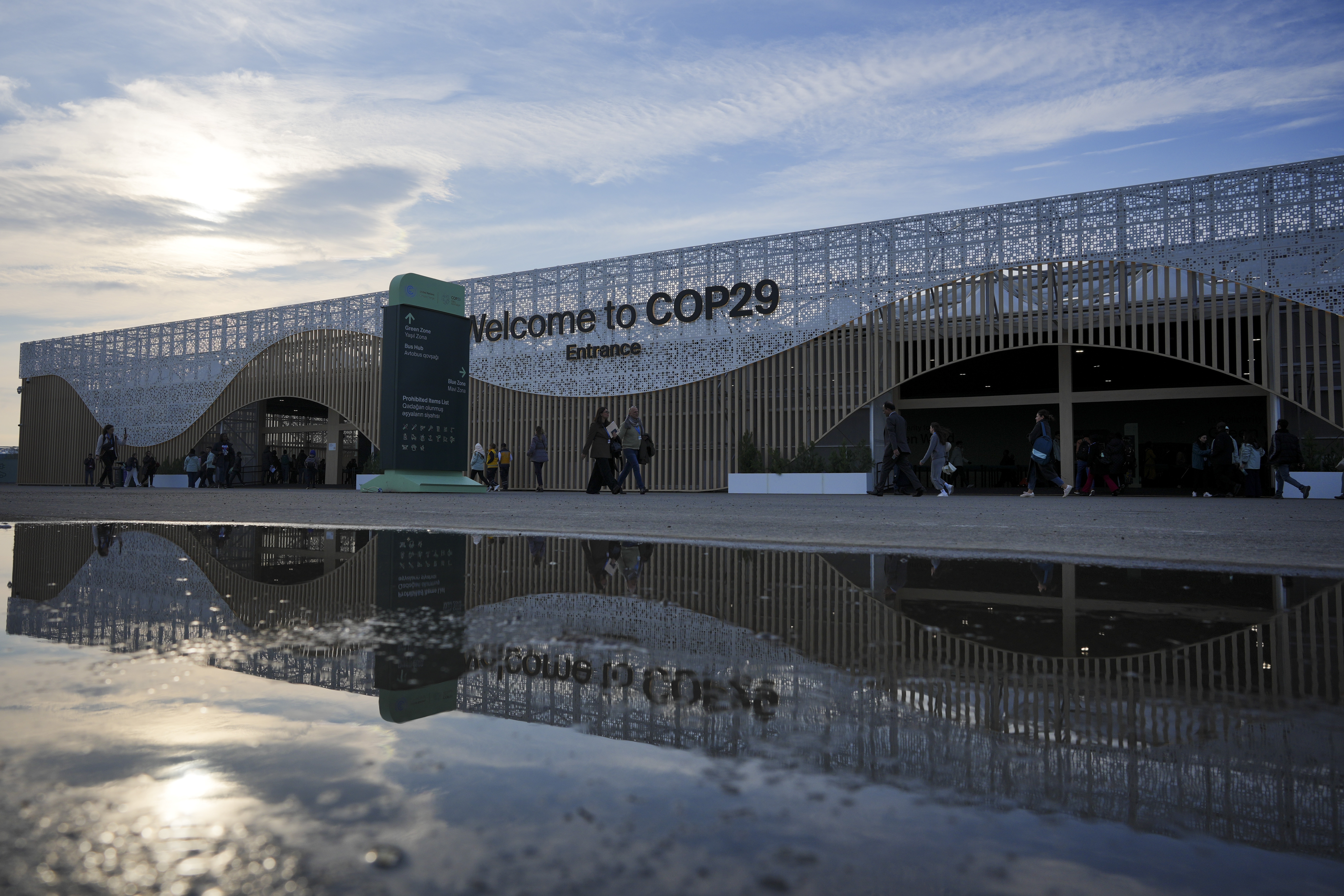 People arrive for the day outside the venue for the COP29 U.N. Climate Summit, Saturday, Nov. 16, 2024, in Baku, Azerbaijan. (AP Photo/Peter Dejong)