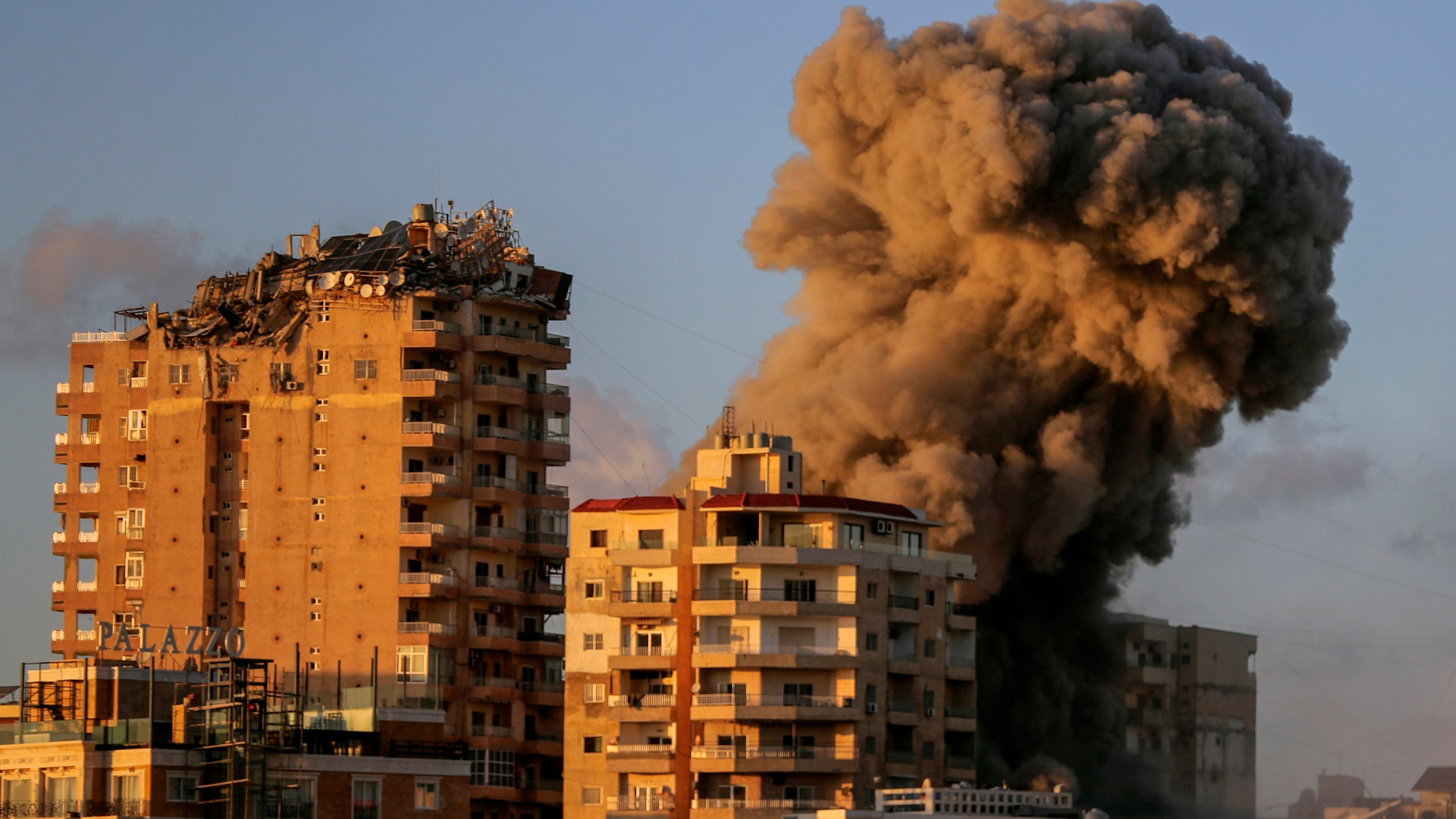 Smoke rises from a building hit in an Israeli airstrike in Tyre, southern Lebanon, Saturday, Nov. 16, 2024. (AP Photo/Mohammed Zaatari)