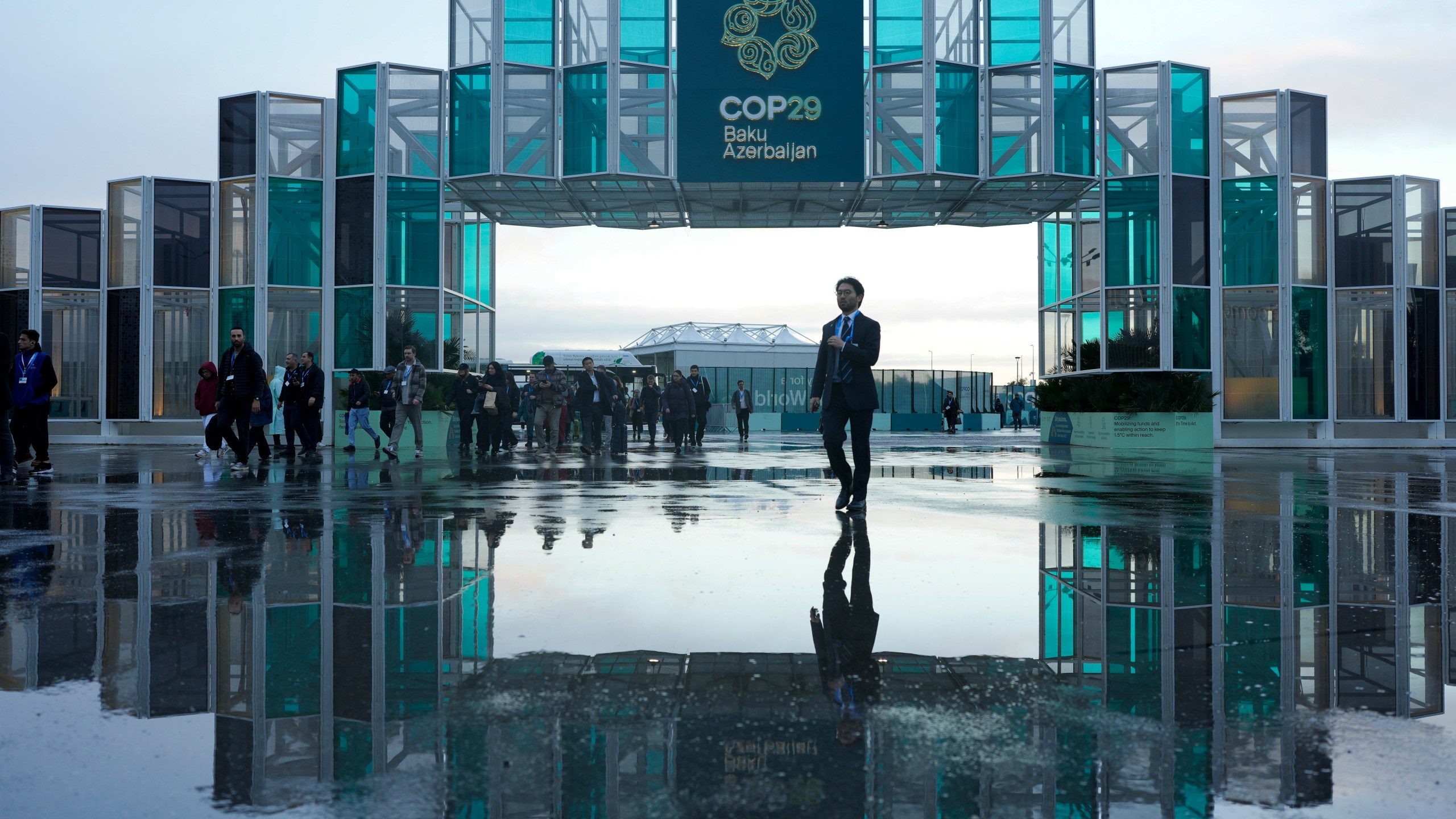 Attendees arrive for the day at the COP29 U.N. Climate Summit, Thursday, Nov. 14, 2024, in Baku, Azerbaijan. (AP Photo/Rafiq Maqbool)