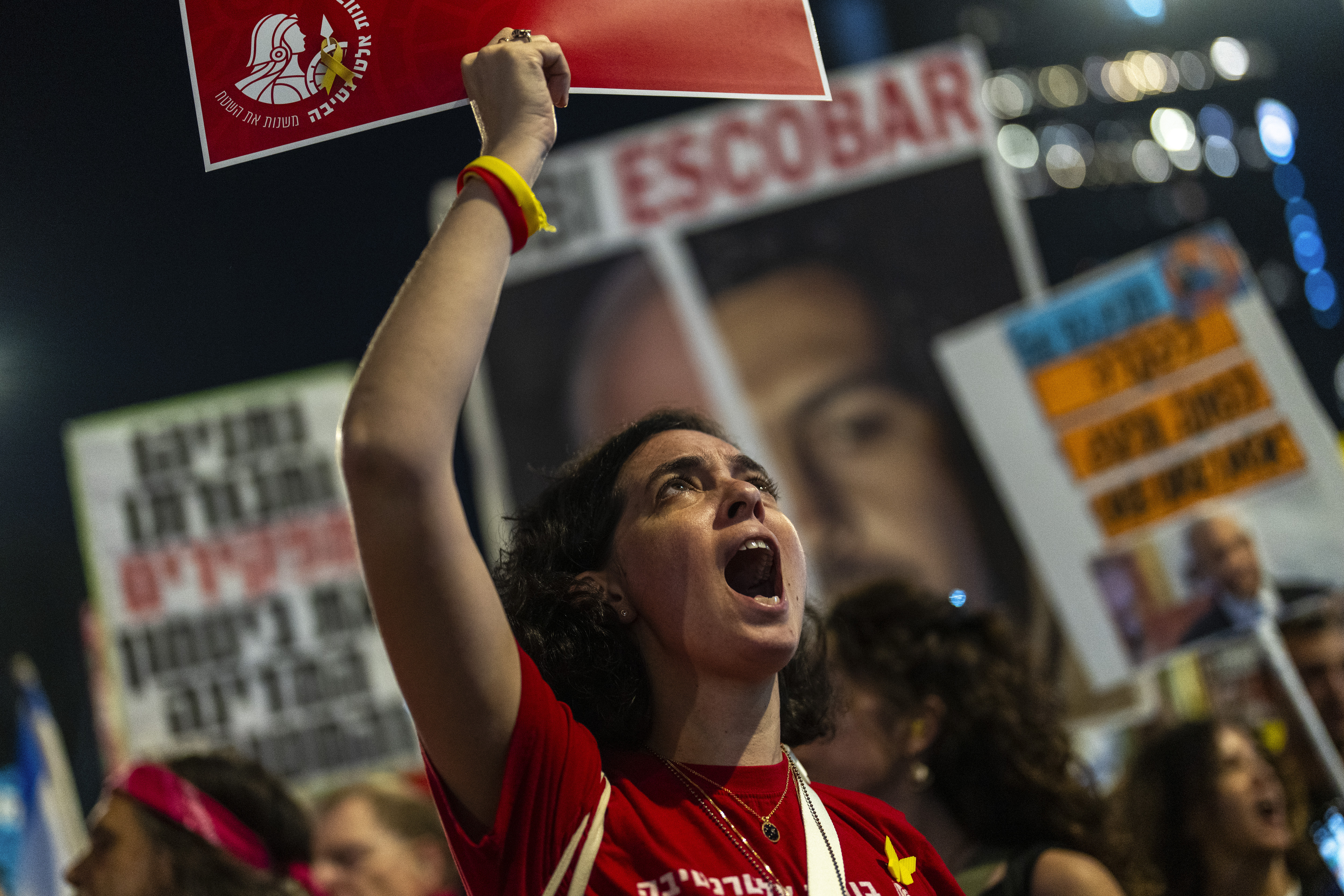 A woman shouts slogans during a protest against Prime Minister Benjamin Netanyahu's government and call for the release of hostages held in the Gaza Strip by the Hamas militant group, in Tel Aviv, Israel, Saturday, Nov. 16, 2024. (AP Photo/Francisco Seco)