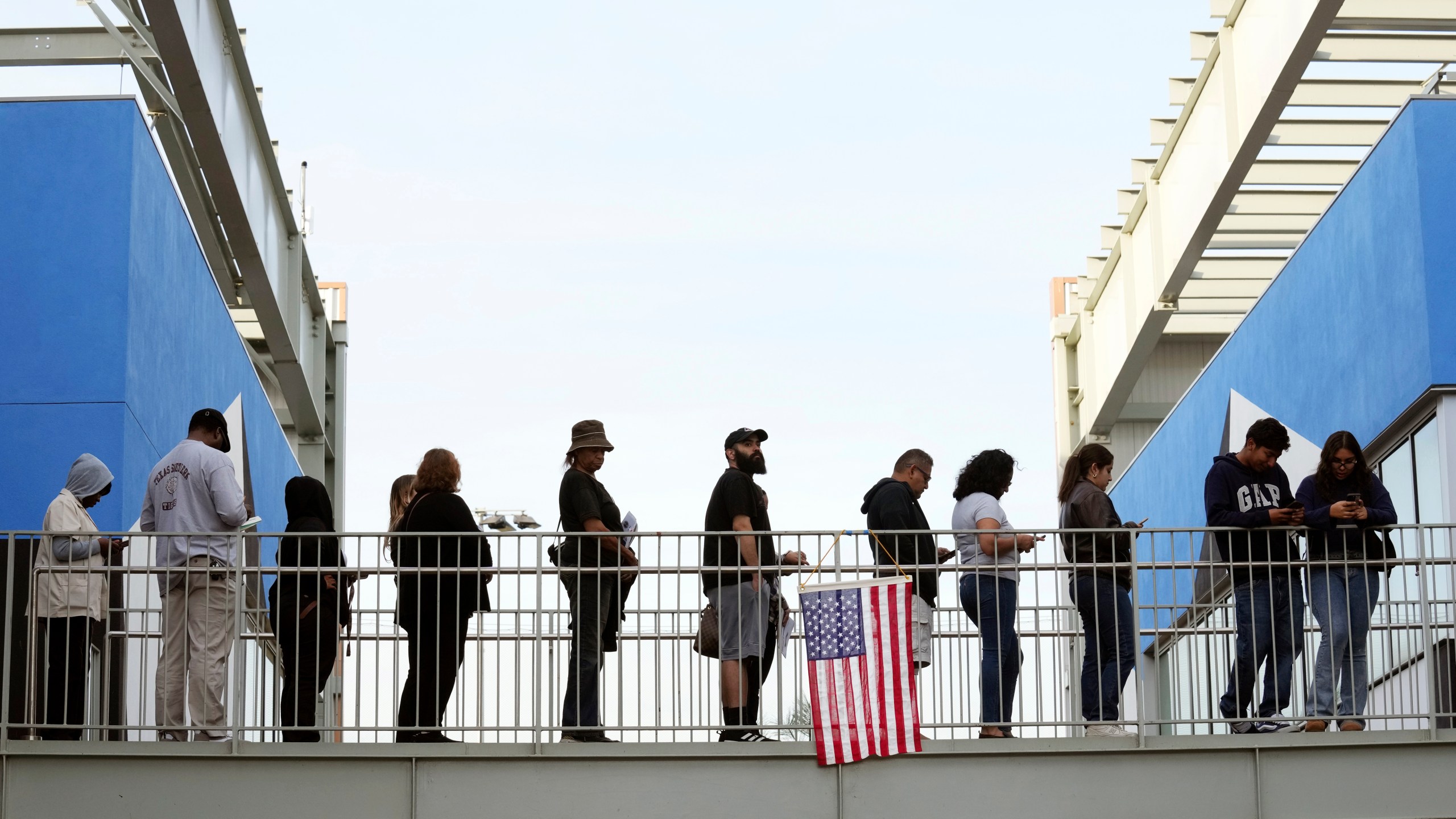 Voters wait in a long line at a polling place at the Michelle and Barack Obama Sports Complex on Election Day, Tuesday, Nov. 5, 2024, in Los Angeles. (AP Photo/Chris Pizzello)