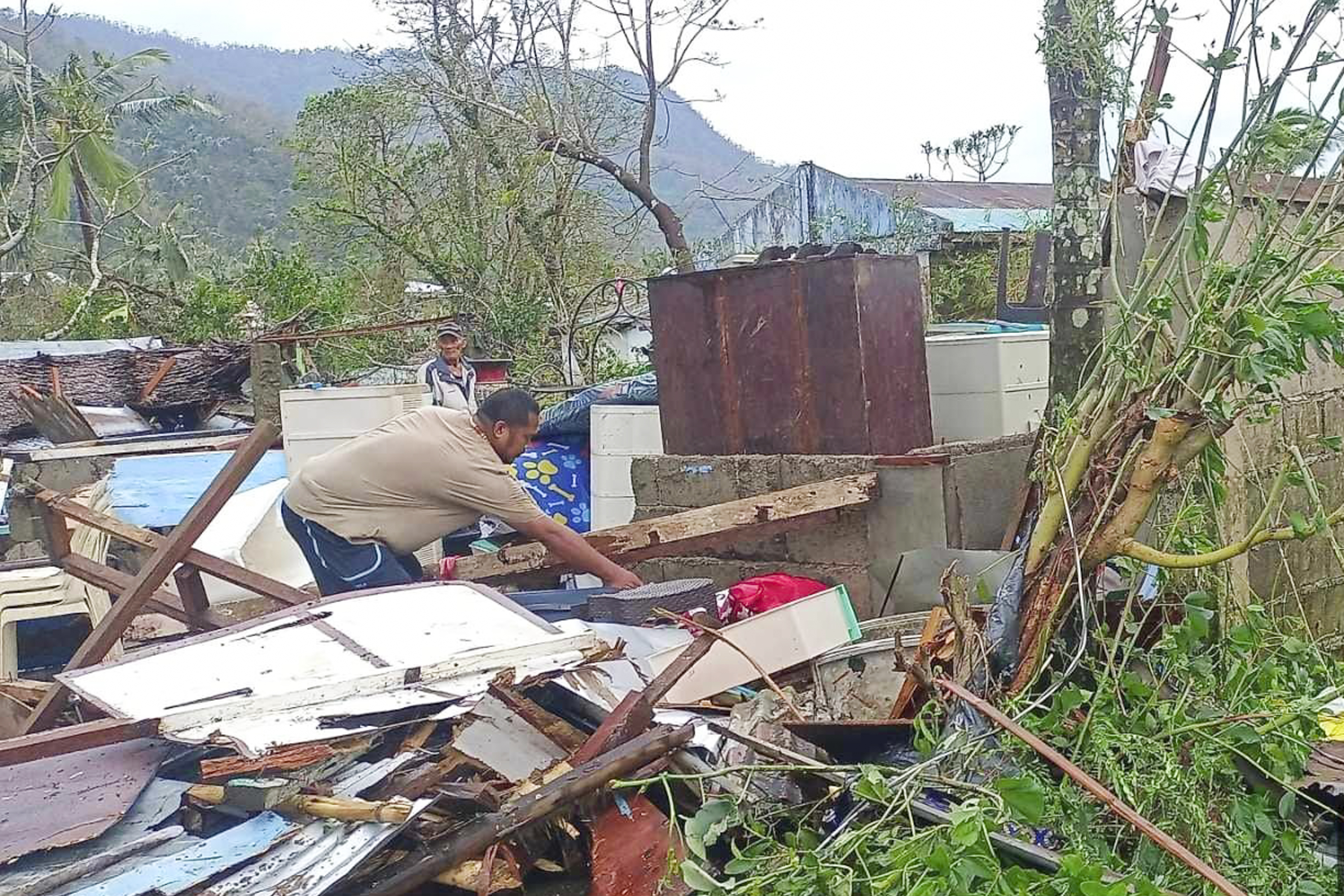 In this photo provided by the MDRRMO Viga Catanduanes, a resident recovers belongings from their damaged homes caused by Typhoon Man-yi in Viga, Catanduanes province, northeastern Philippines Sunday, Nov. 17, 2024. (MDRRMO Viga Catanduanes via AP)