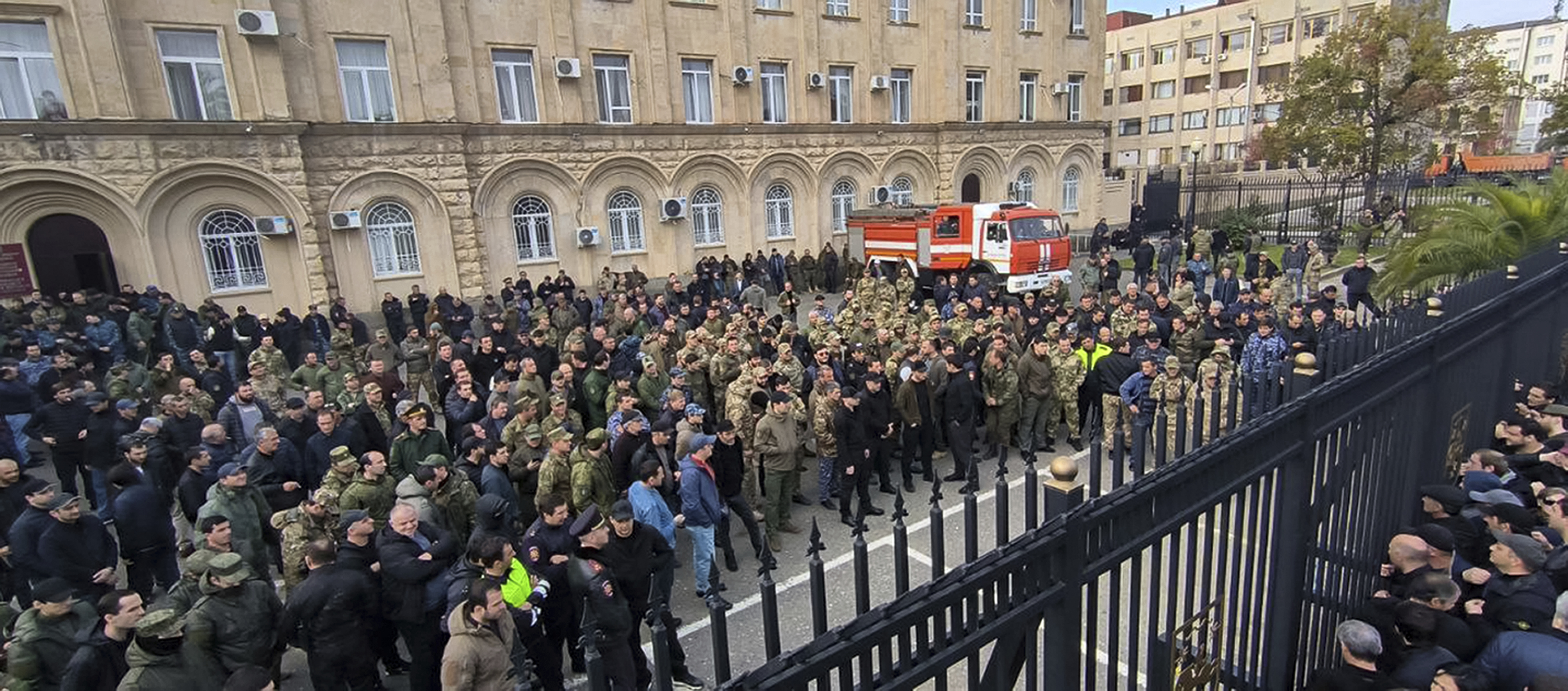 In this photo taken from video released by AIASHARA Independent Agency, Protesters gather outside the parliament building of the Georgian separatist region of Abkhazia as tensions flared over a proposed pact that would allow Russians to buy apartments in the region, Georgia, on Friday, Nov. 15, 2024, (AIASHARA Independent Agency via AP)