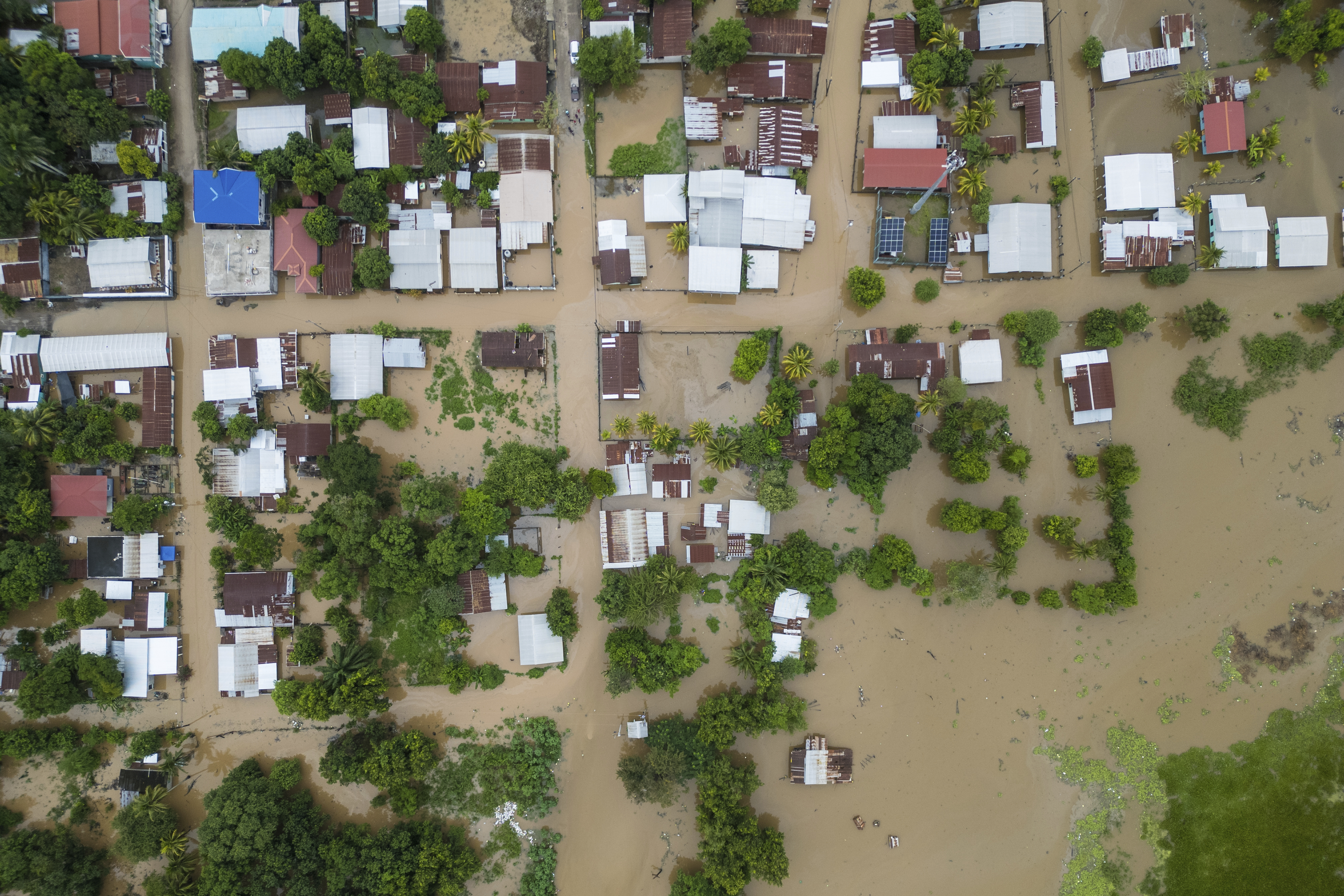 An Aerial view shows the Suyapa neighborhood, partially flooded by the Ulúa River's overflow after Tropical Storm Sara, in Potrerillos, Honduras, Sunday, Nov. 17, 2024. (AP Photo/Moises Castillo)