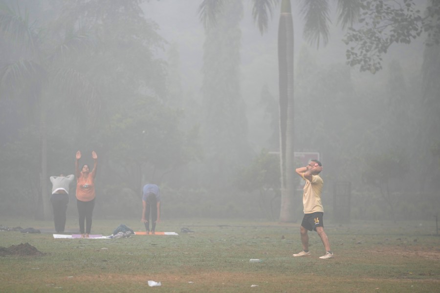 Bashir Ahmad Mir performs morning exercises surrounded by smog in Lodhi Gardens in New Delhi, India, Friday, Nov. 15, 2024. (AP Photo/Manish Swarup)