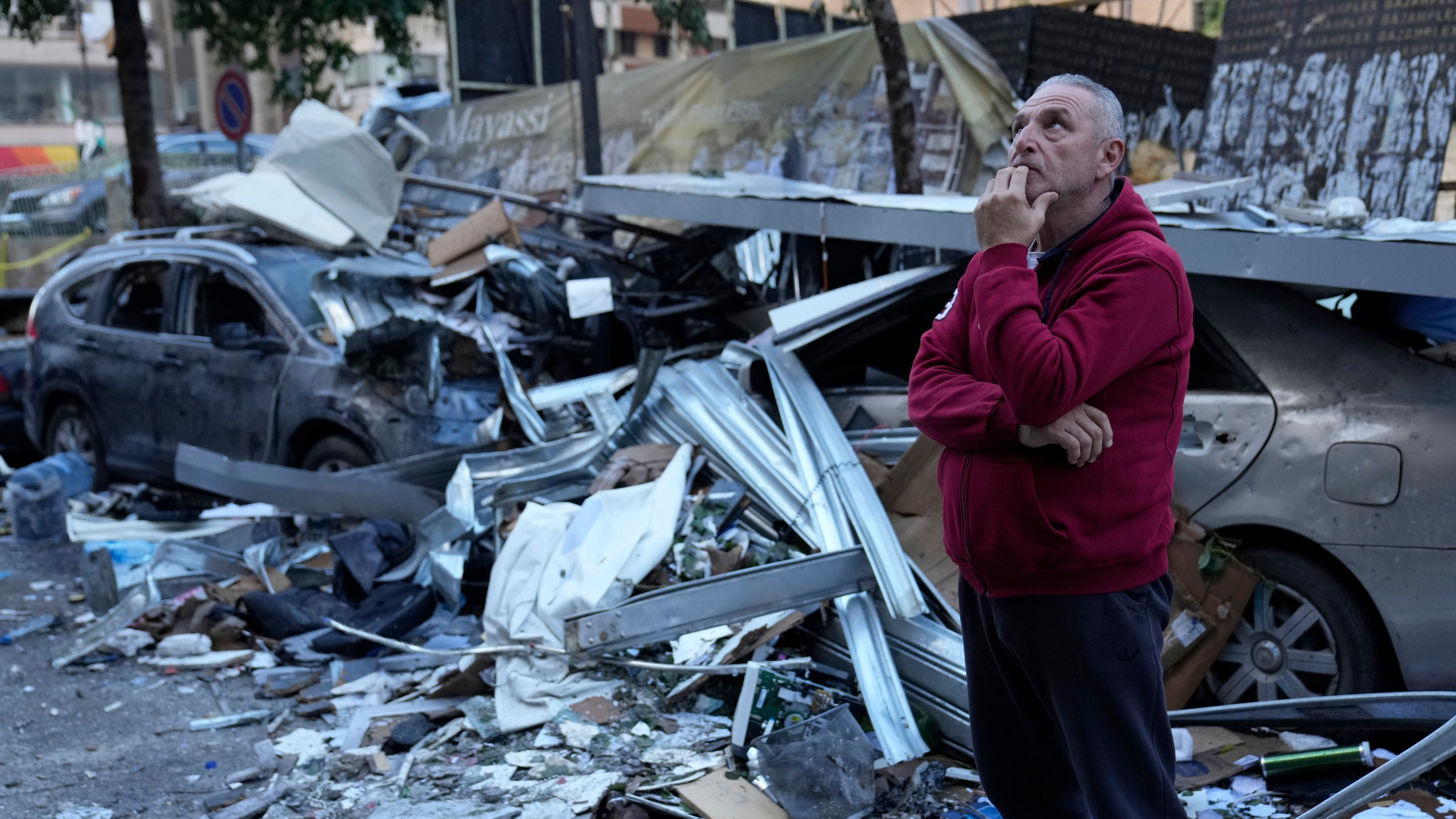 A man watches the damage at the site where an Israeli airstrike Sunday evening hit in central Beirut, Lebanon, Monday, Nov. 18, 2024. (AP Photo/Hussein Malla)