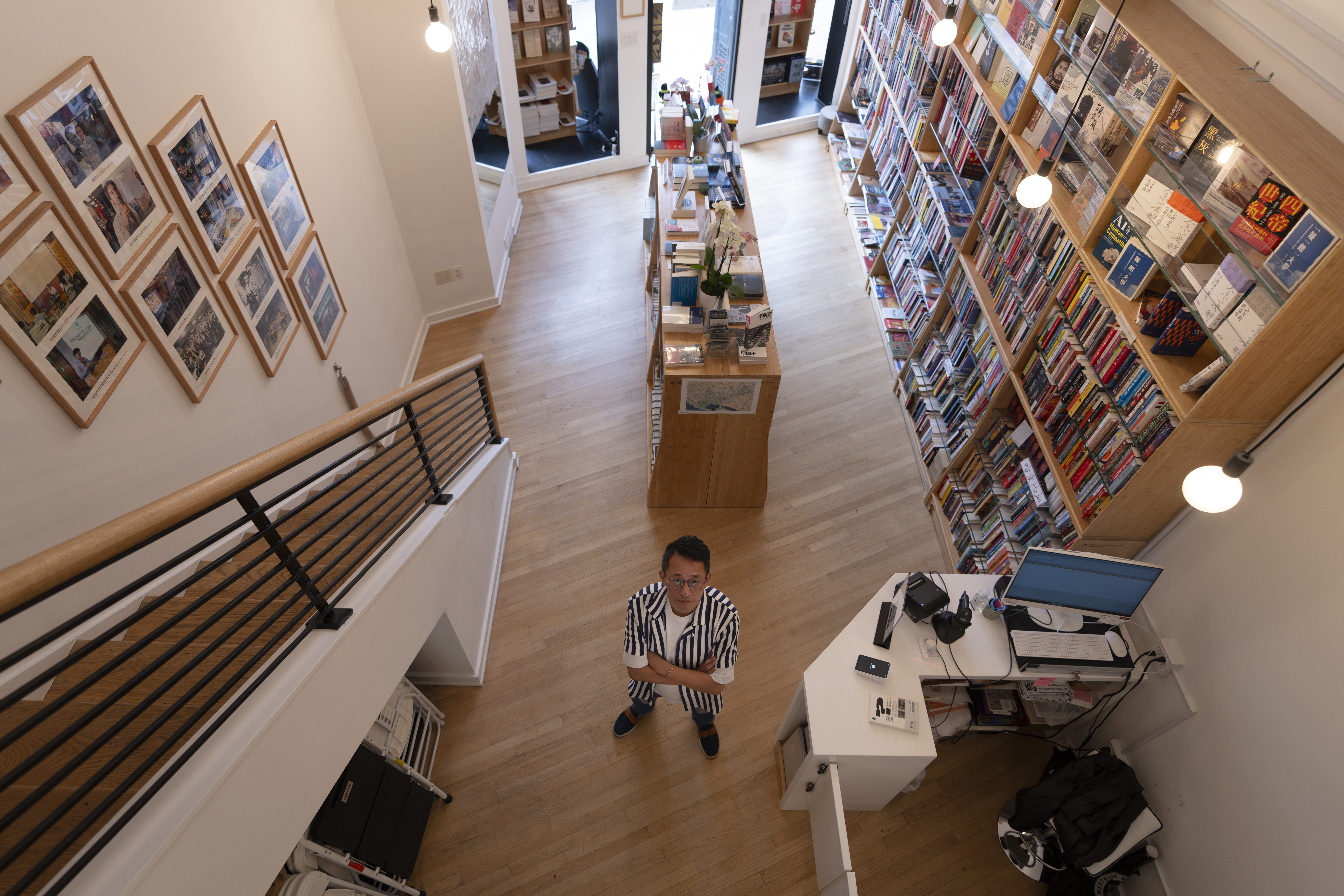 Yu Miao, owner of JF Books, poses for a photograph in his bookstore in Washington, Thursday, Oct. 3, 2024. (AP Photo/Ben Curtis)