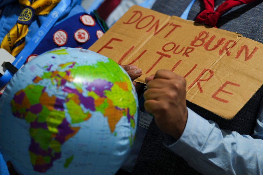 A demonstrators holds a sign that reads "don't burn our future" at the COP29 U.N. Climate Summit, Monday, Nov. 18, 2024, in Baku, Azerbaijan. (AP Photo/Peter Dejong)