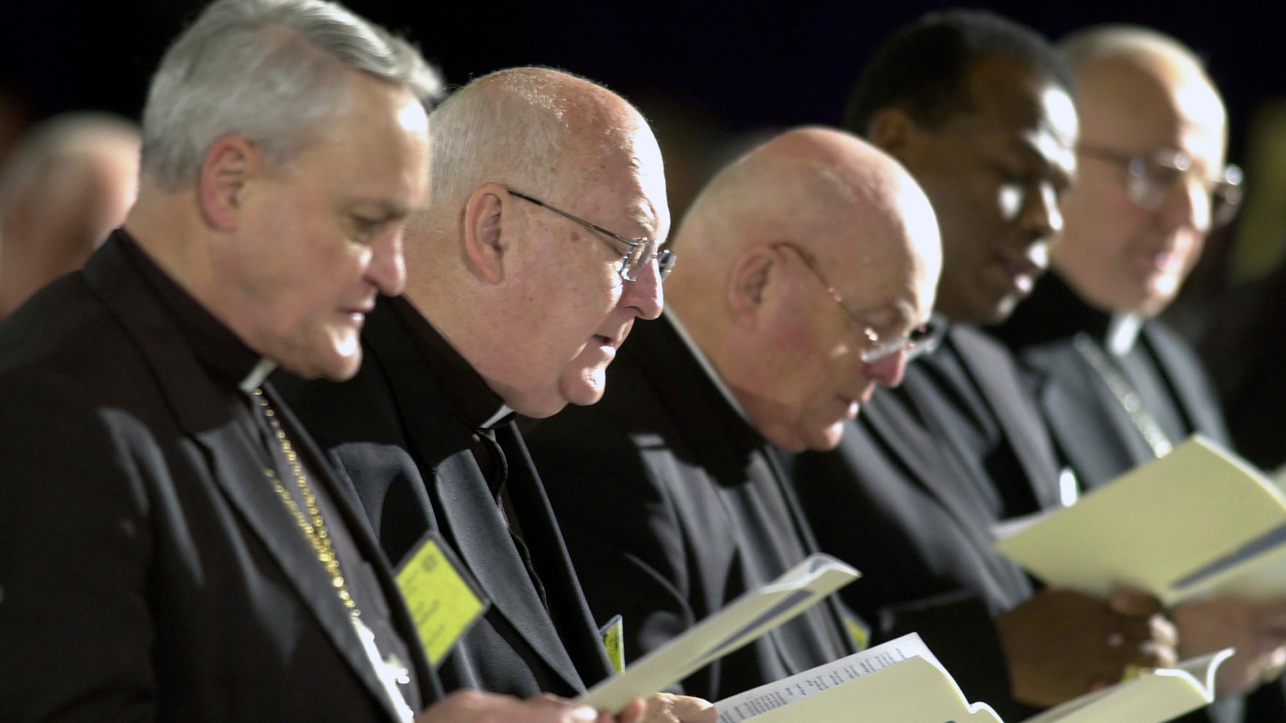 FILE - Bishops sing a hymn during the opening of Friday morning session at the U.S. Conference of Catholic Bishops' meeting in Dallas, June 14. 2002. (AP Photo/Charlie Riedel, file)