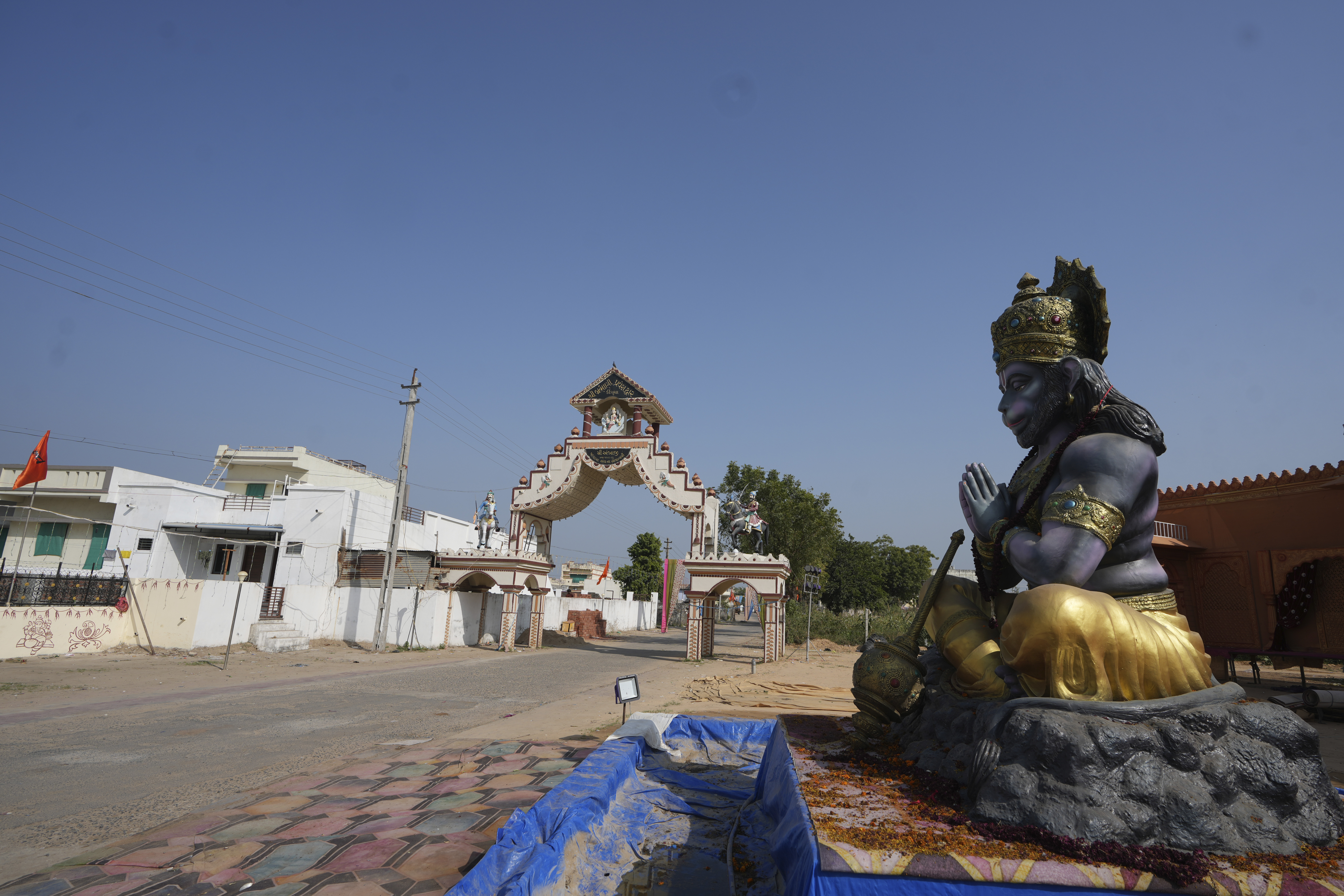 A statue of Monkey God Hanuman, installed as part of a religious celebrations, is seen in front of an entrance gate of Dingucha village in Gandhinagar, India, Tuesday, Nov. 12, 2024. (AP Photo/Ajit Solanki)