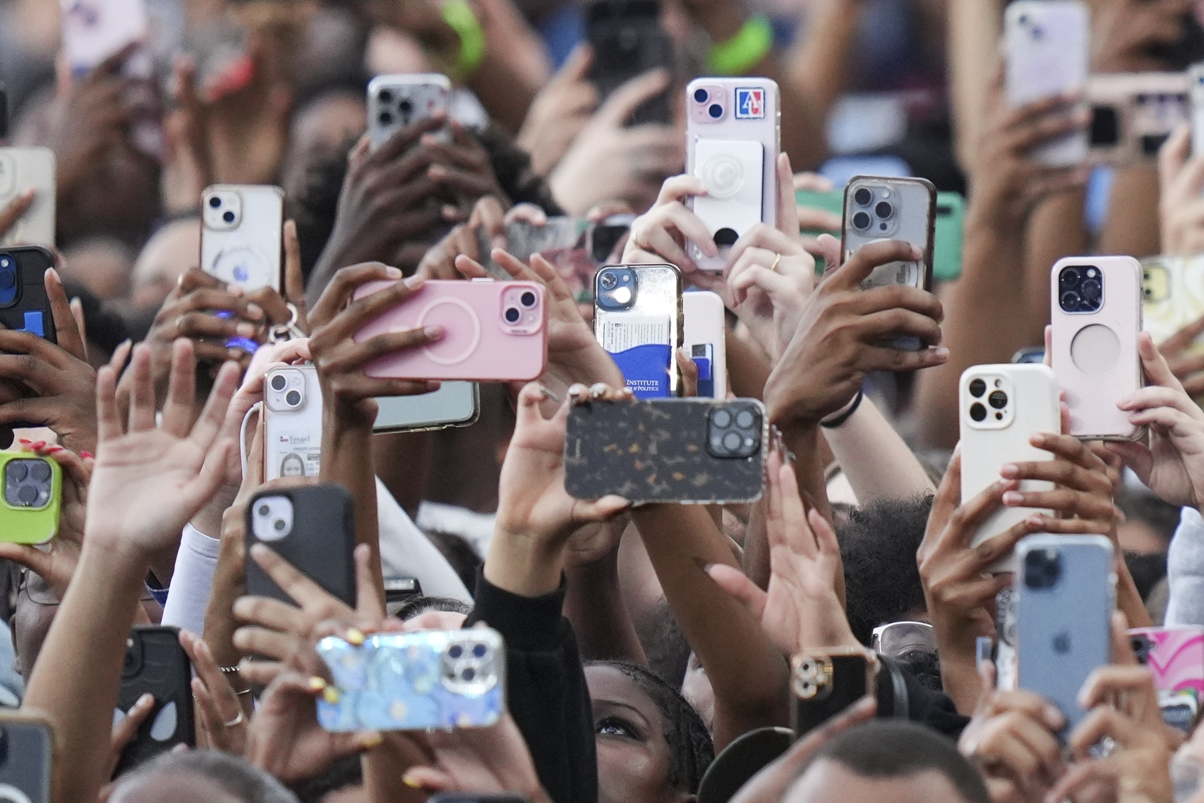 Supporters of Vice President Kamala Harris hold up their phones as she delivers a concession speech for the 2024 presidential election, Wednesday, Nov. 6, 2024, on the campus of Howard University in Washington. (AP Photo/Stephanie Scarbrough)