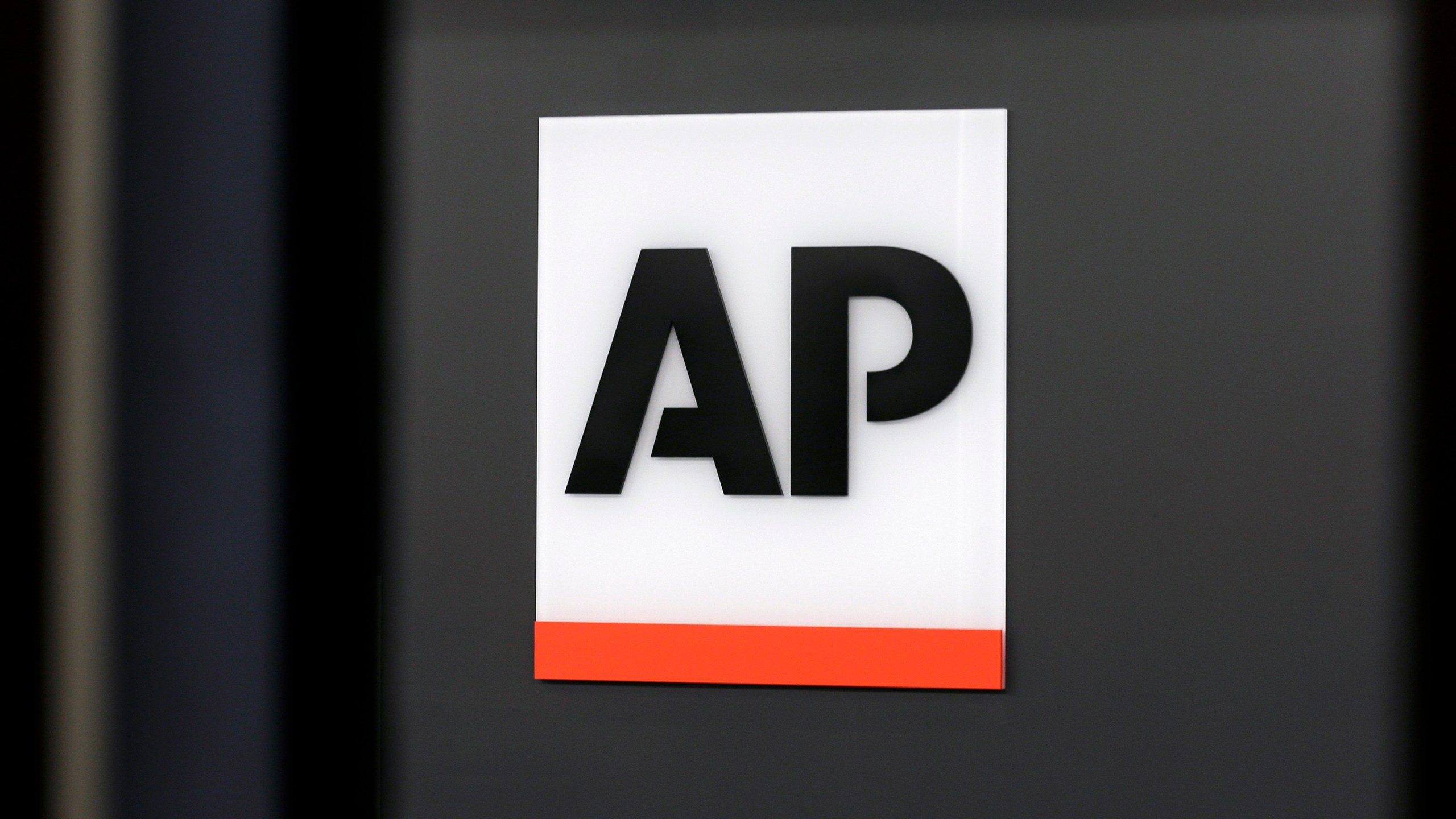 FILE - The Associated Press logo is displayed at the company's headquarters on April 18, 2017, in New York. (AP Photo/Jenny Kane, File)