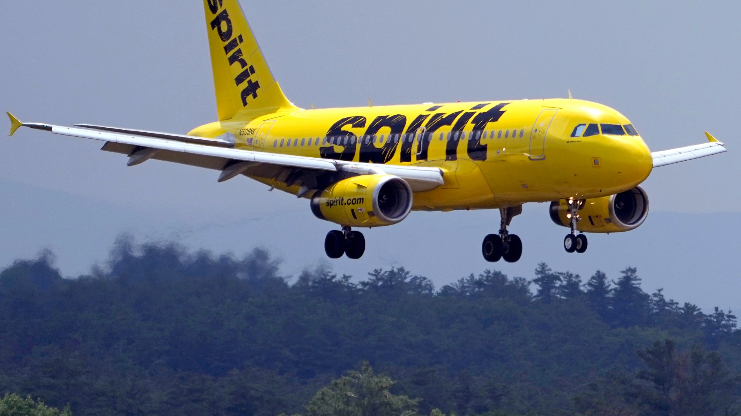 FILE - A Spirit Airlines 319 Airbus approaches Manchester Boston Regional Airport for a landing, Friday, June 2, 2023, in Manchester, N.H. (AP Photo/Charles Krupa, File)