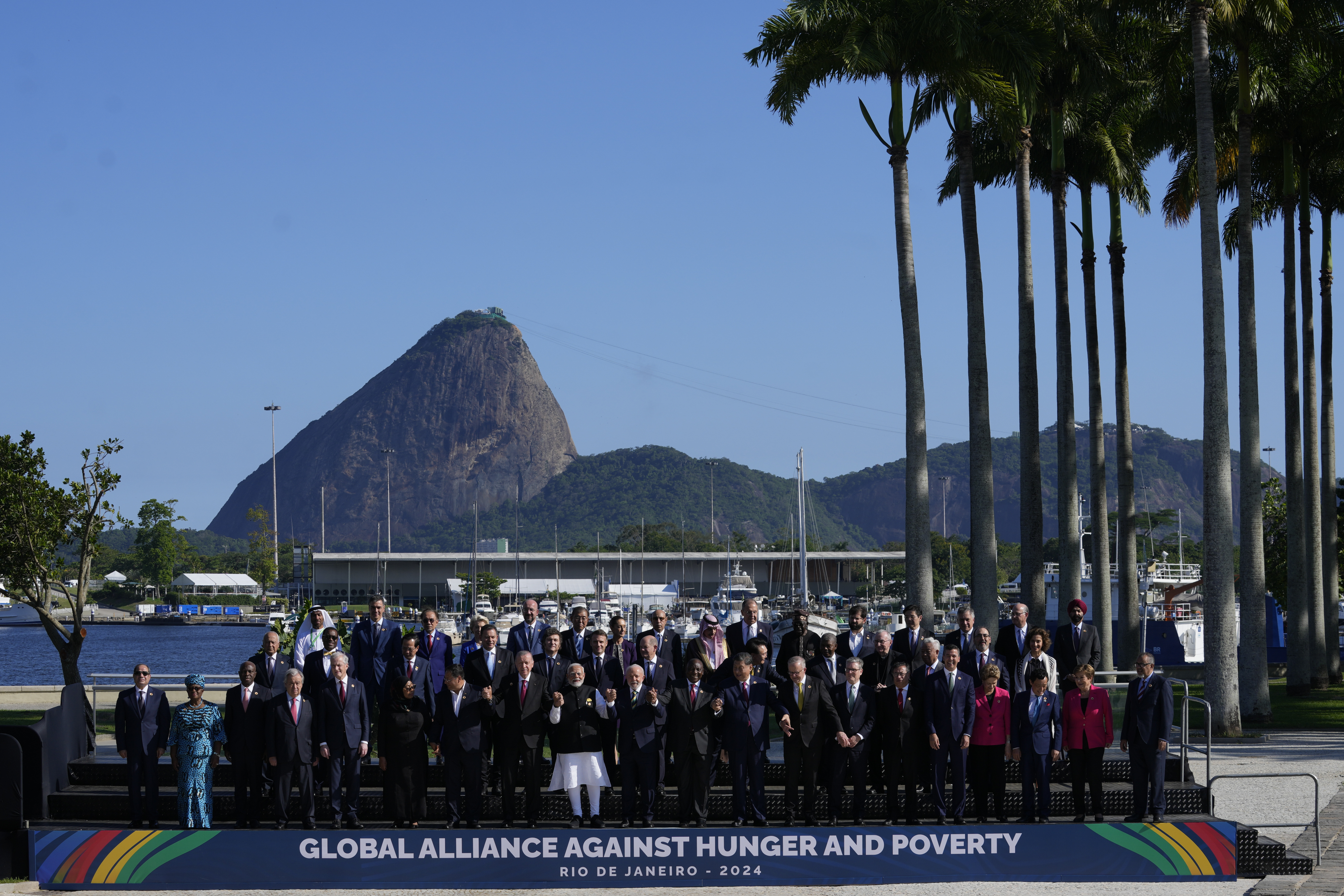 Backdropped by Sugar Loaf mountain, leaders attending the G20 Summit pose for a group photo in Rio de Janeiro, Monday, Nov. 18, 2024. (AP Photo/Eraldo Peres)