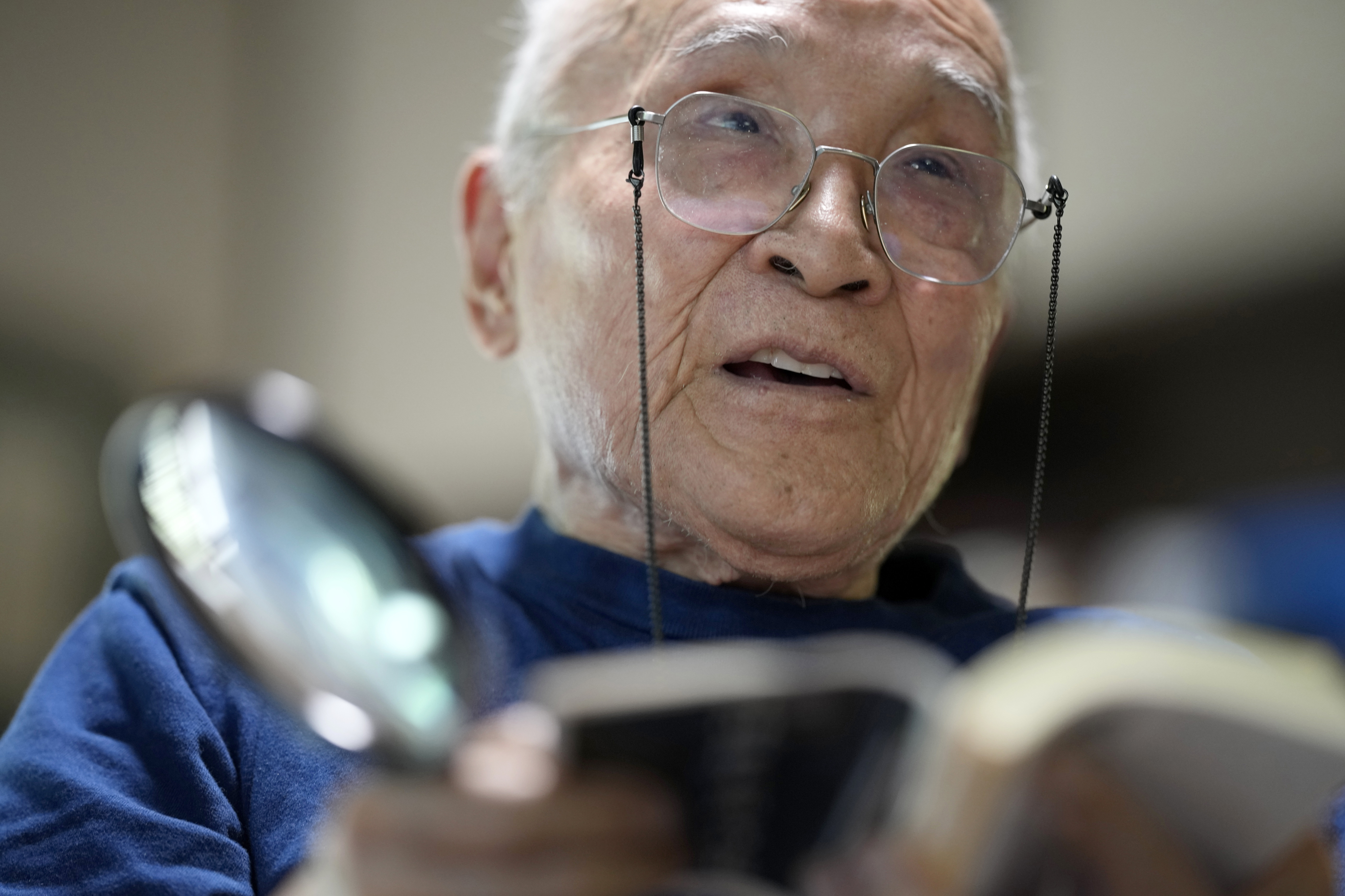 FILE - Shuntaro Tanikawa, a Japanese poet and translator, reads his poem during an interview with The Associated Press in Tokyo, on May 25, 2022. (AP Photo/Eugene Hoshiko, File)