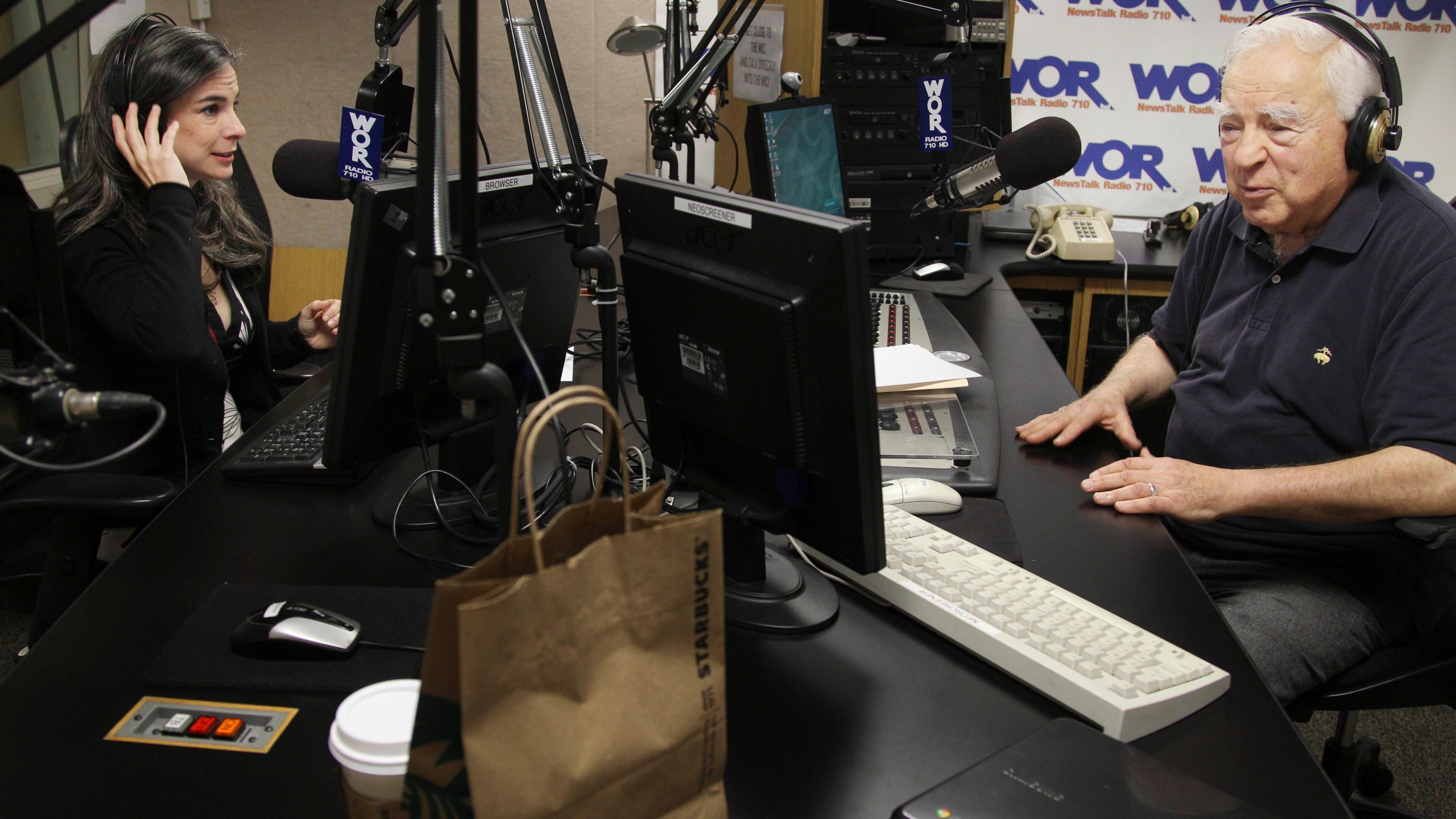 FILE - Arthur Frommer, 83, and his daughter, Pauline Frommer, 46, prepare for their radio show at the WOR studios in New York, May 20, 2012. (AP Photo/Seth Wenig, File)