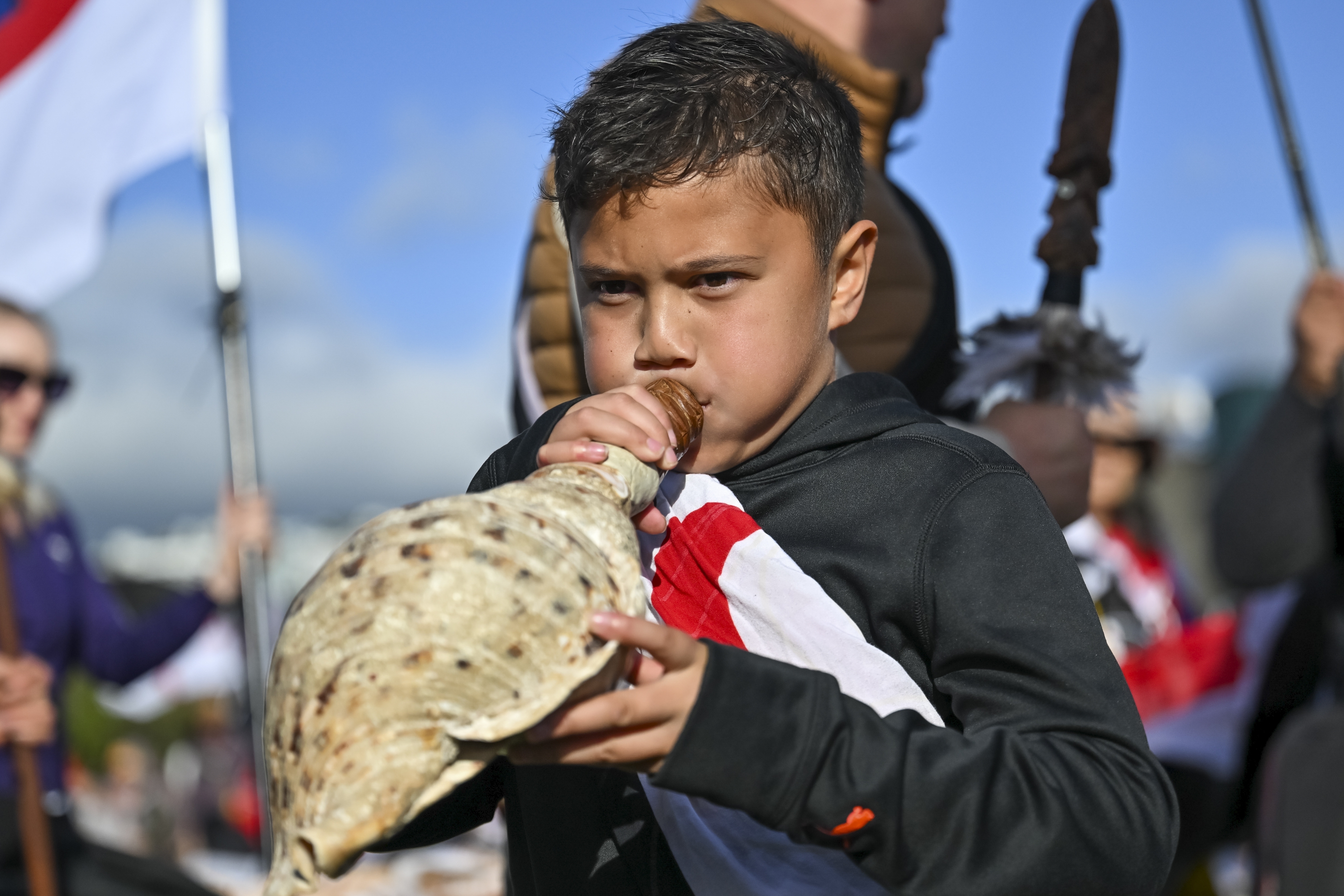 Te Haukūnui Hokianga plays a conch shell ahead of a protest at New Zealand's parliament against a proposed law that would redefine the country's founding agreement between Indigenous Māori and the British Crown, in Wellington, New Zealand, Tuesday, Nov. 19, 2024. (AP Photo/Mark Tantrum)