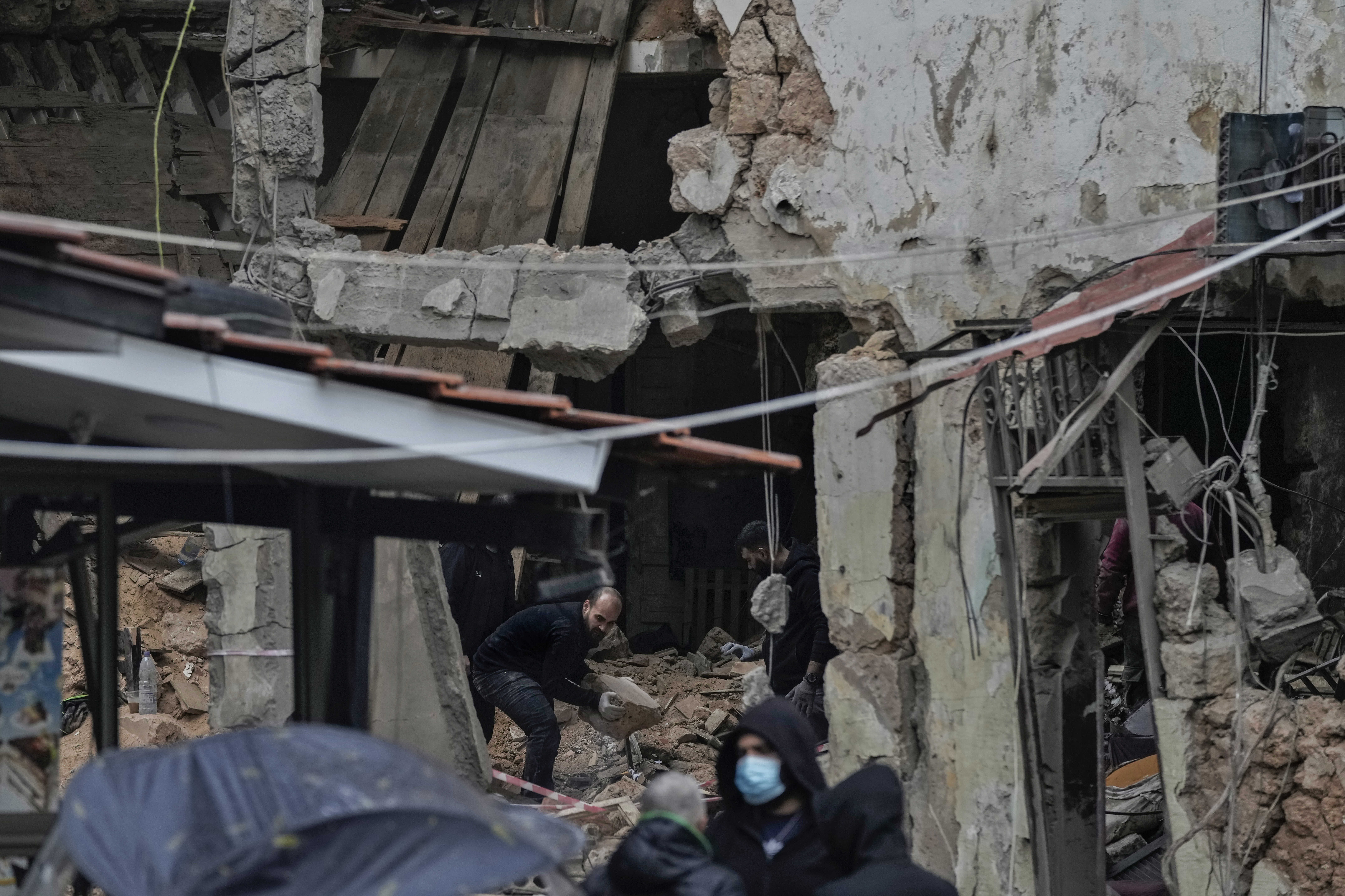 People inspect a destroyed building hit on Monday evening by an Israeli airstrike in central Beirut, Lebanon, Tuesday, Nov. 19, 2024. (AP Photo/Bilal Hussein)