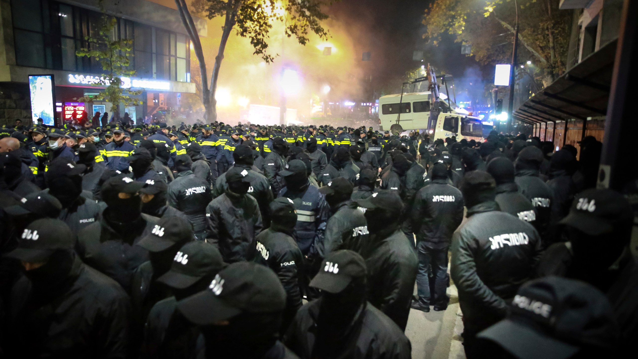 Police gather to push protesters away from a street during a rally against the results of the parliamentary elections amid allegations that the vote was rigged in Tbilisi, Georgia, on Tuesday, Nov. 19, 2024. (AP Photo/Zurab Tsertsvadze)