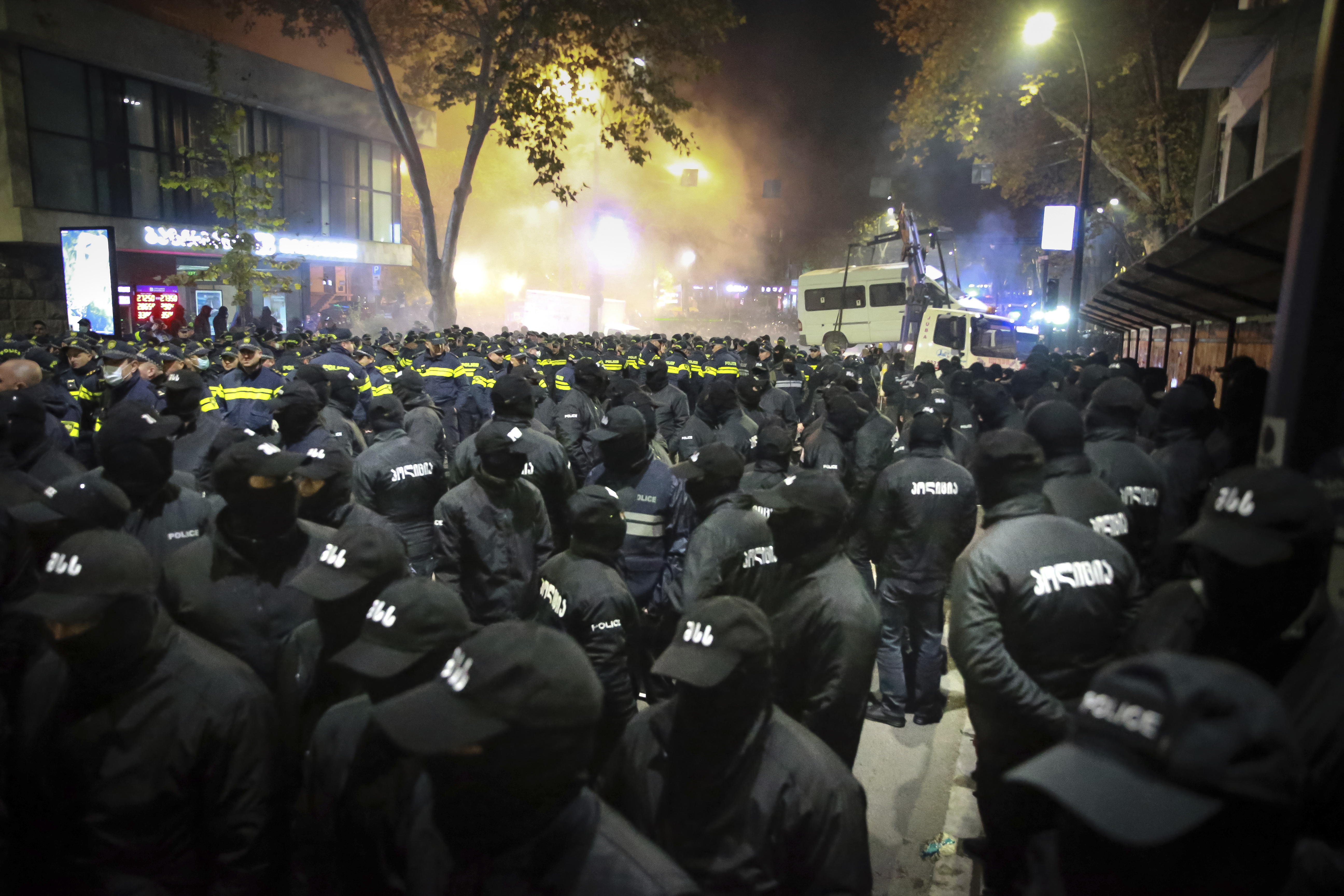 Police gather to push protesters away from a street during a rally against the results of the parliamentary elections amid allegations that the vote was rigged in Tbilisi, Georgia, on Tuesday, Nov. 19, 2024. (AP Photo/Zurab Tsertsvadze)