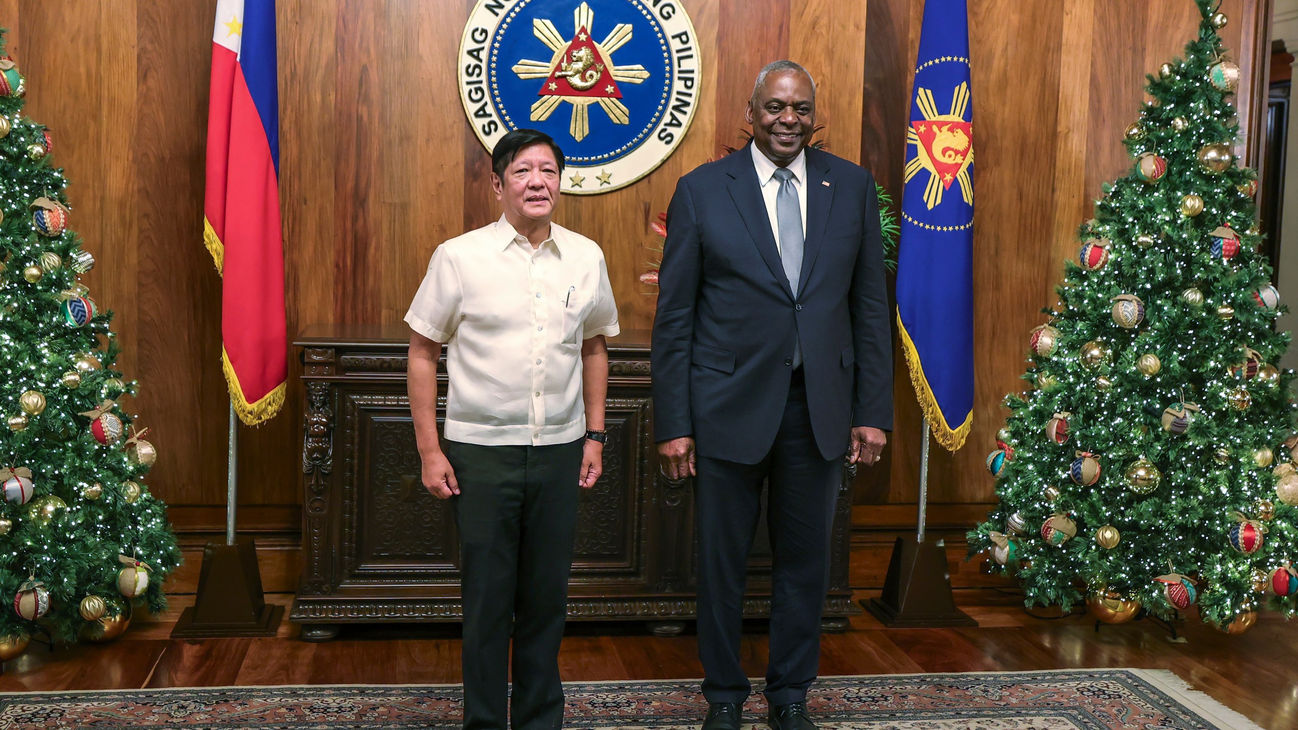 U.S. Defense Secretary Lloyd Austin, right, and Philippine President Ferdinand Marcos Jr. pose for a photograph during a courtesy call at the Malacanang Palace in Manila, Philippines Monday, Nov. 18, 2024. (AP Photo/Gerard Carreon, Pool)