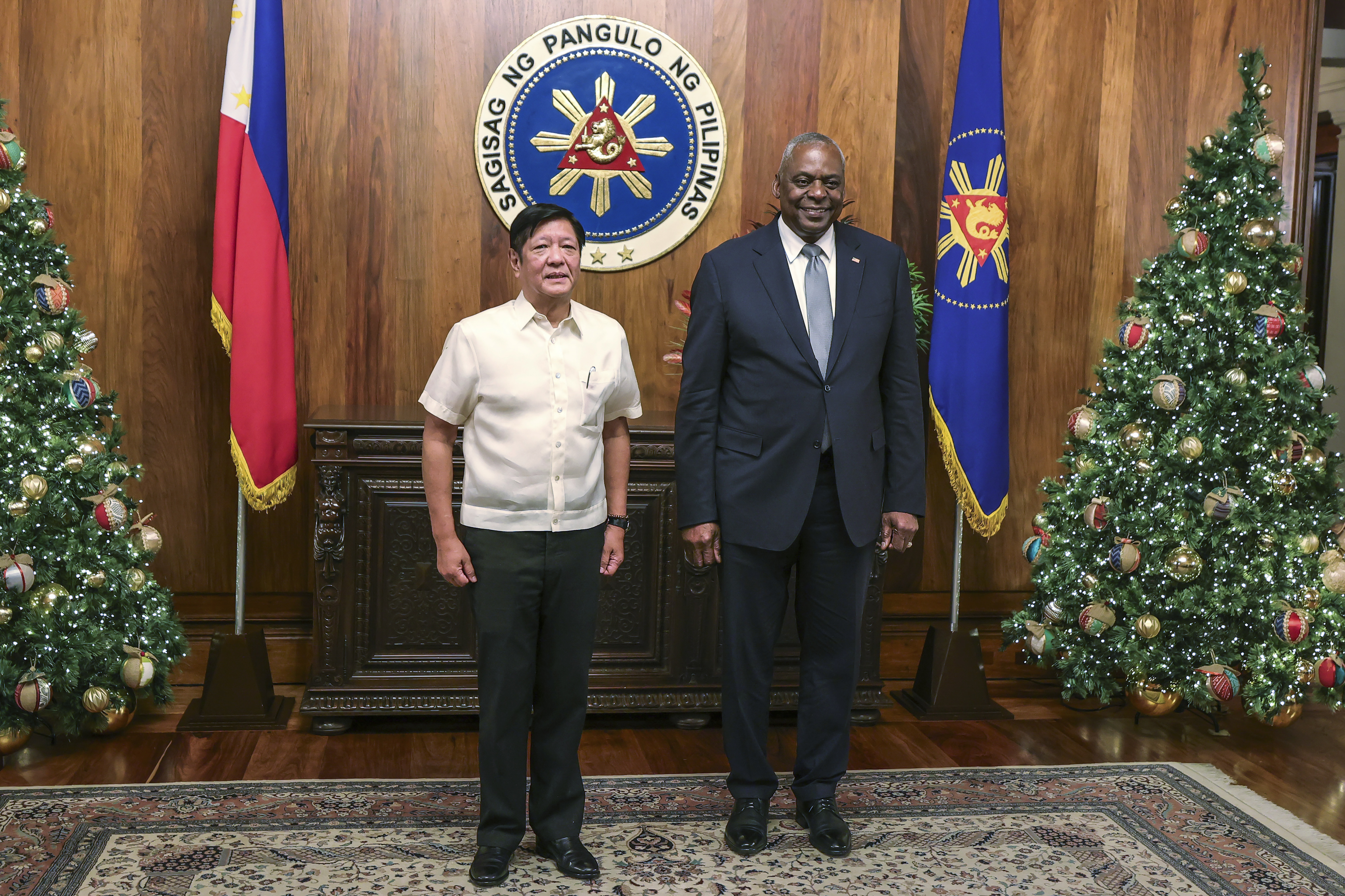 U.S. Defense Secretary Lloyd Austin, right, and Philippine President Ferdinand Marcos Jr. pose for a photograph during a courtesy call at the Malacanang Palace in Manila, Philippines Monday, Nov. 18, 2024. (AP Photo/Gerard Carreon, Pool)