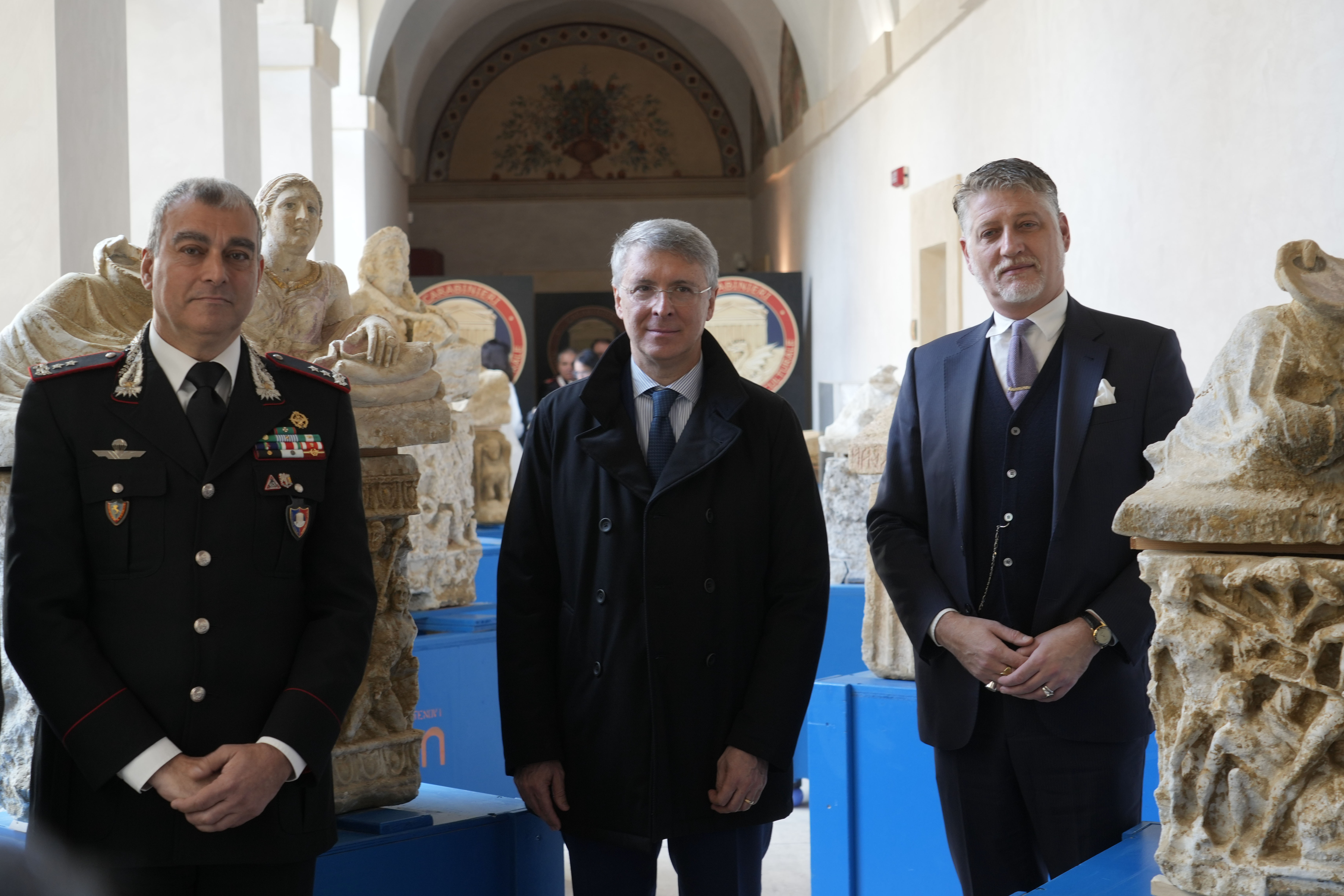 Italian Culture Minister Alessandro Giuli, right, Perugia' Chief Prosecutor Raffaele Cantone, center, and Carabinieri General Francesco Gargano pose for photographers near archaeological finds from the Etruscan era during a press conference in Rome, Tuesday, Nov. 19, 2024. (AP Photo/Gregorio Borgia)