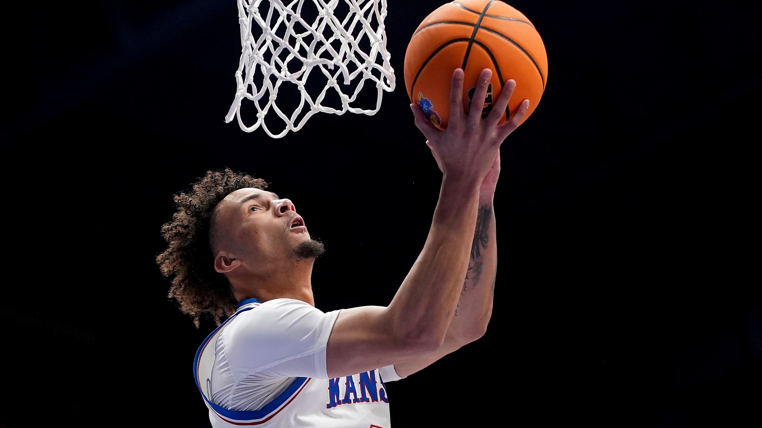 Kansas guard Zeke Mayo shoots during the first half of an NCAA college basketball game against UNC Wilmington Tuesday, Nov. 19, 2024, in Lawrence, Kan. (AP Photo/Charlie Riedel)