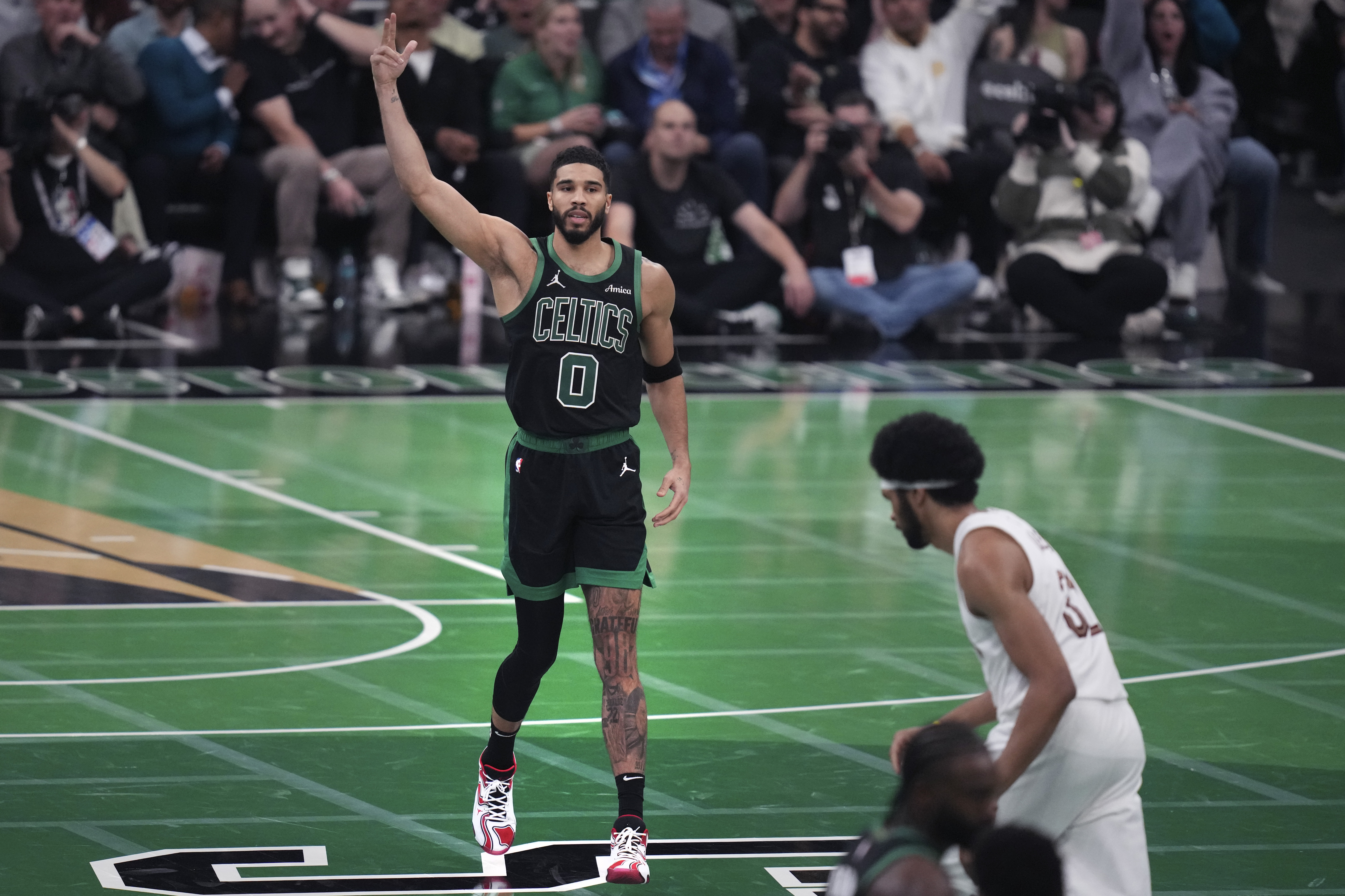 Boston Celtics forward Jayson Tatum (0) celebrates after hitting a 3-pointer during the second half of an Emirates NBA Cup basketball game against the Cleveland Cavaliers, Tuesday, Nov. 19, 2024, in Boston. (AP Photo/Charles Krupa)