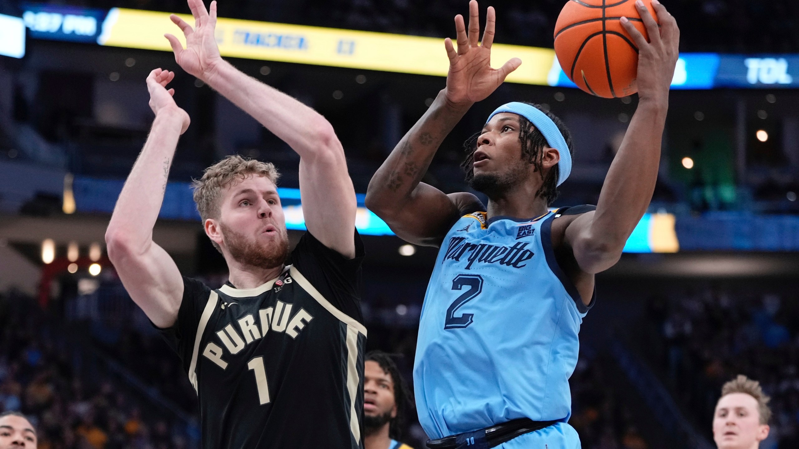 Marquette's Chase Ross shoots past Purdue's Caleb Furst during the first half of an NCAA college basketball game Tuesday, Nov. 19, 2024, in Milwaukee. (AP Photo/Morry Gash)