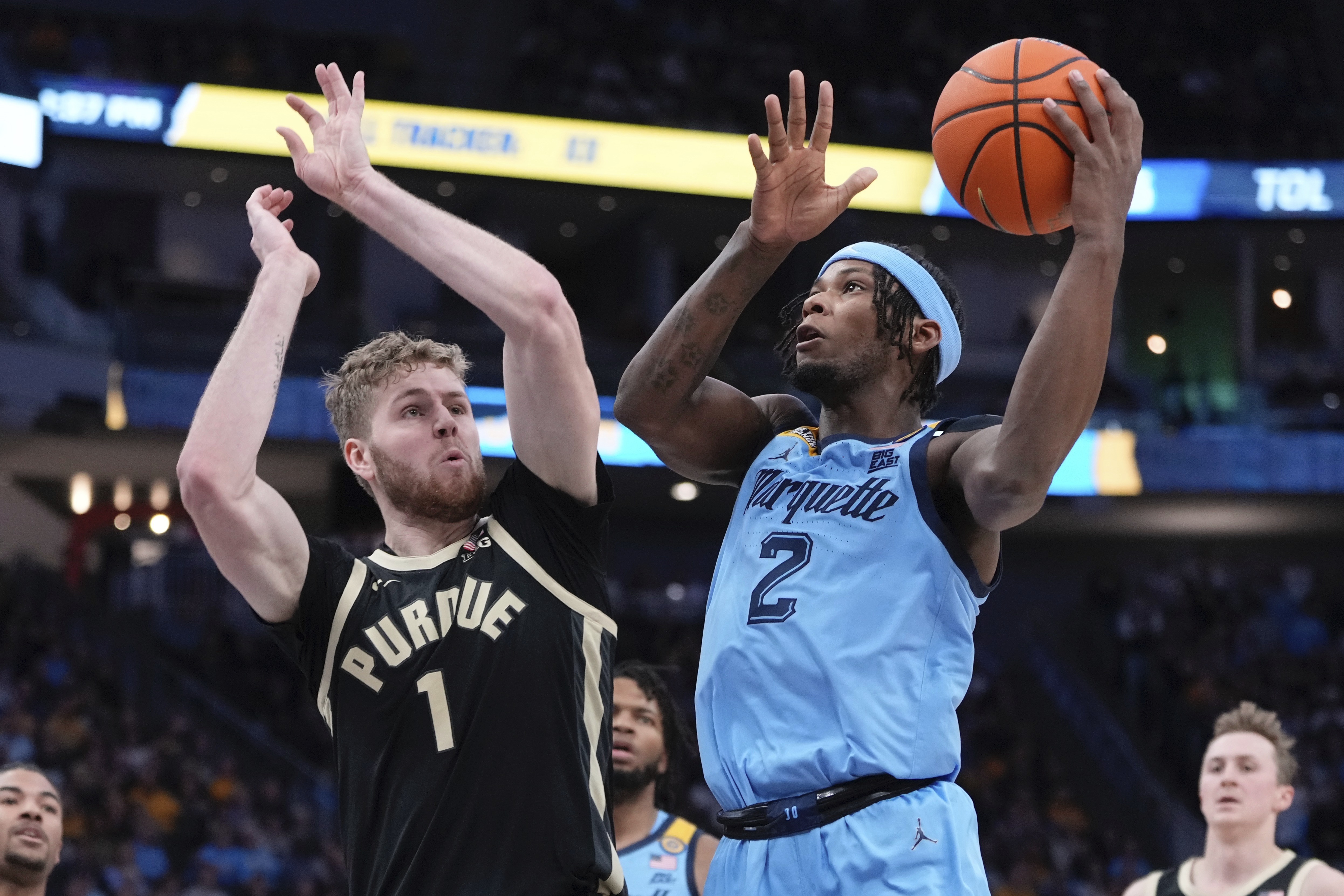 Marquette's Chase Ross shoots past Purdue's Caleb Furst during the first half of an NCAA college basketball game Tuesday, Nov. 19, 2024, in Milwaukee. (AP Photo/Morry Gash)