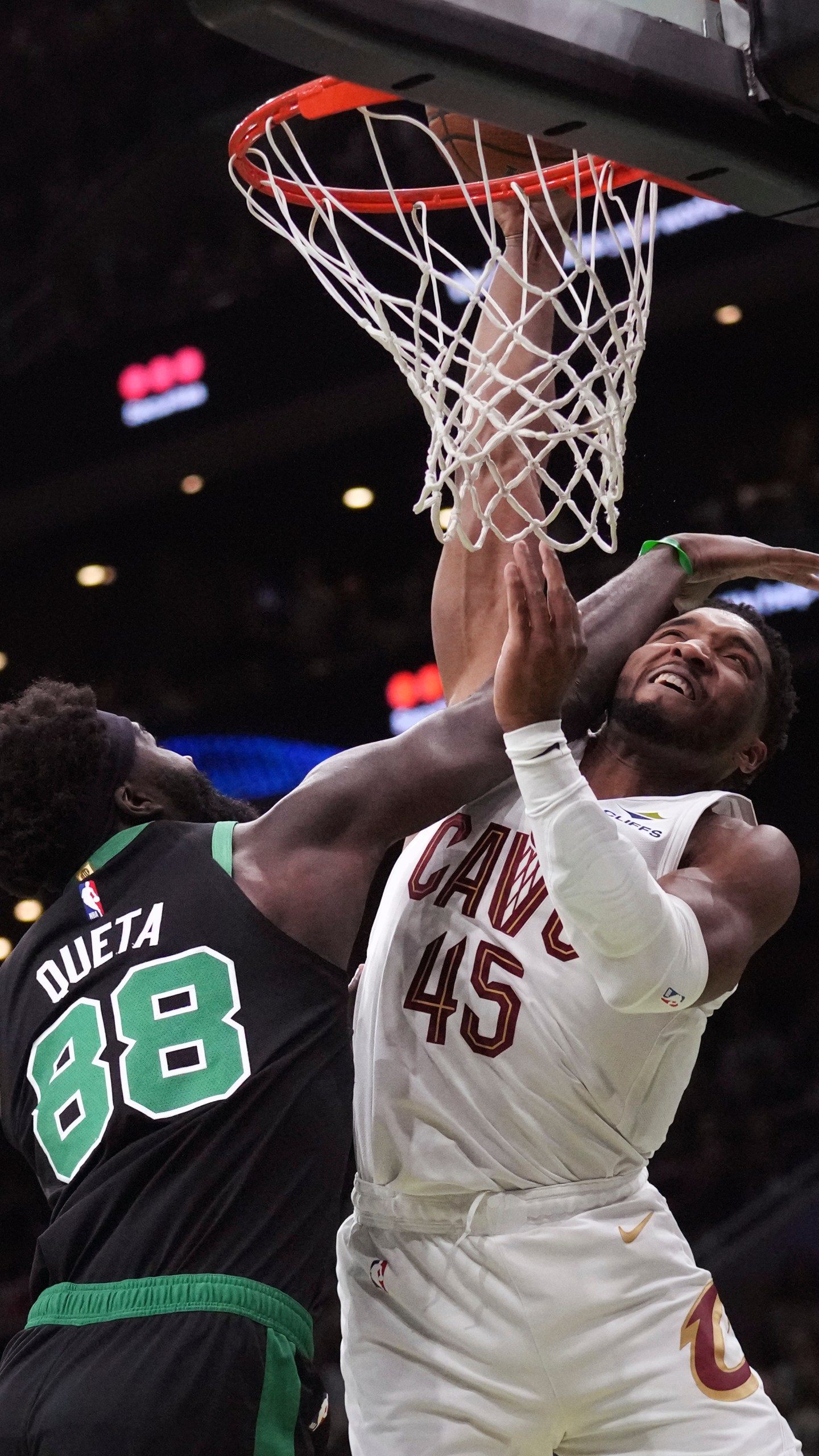 Boston Celtics center Neemias Queta (88) fouls Cleveland Cavaliers guard Donovan Mitchell (45) on a drive to the basket during the first half of an Emirates NBA Cup basketball game, Tuesday, Nov. 19, 2024, in Boston. (AP Photo/Charles Krupa)