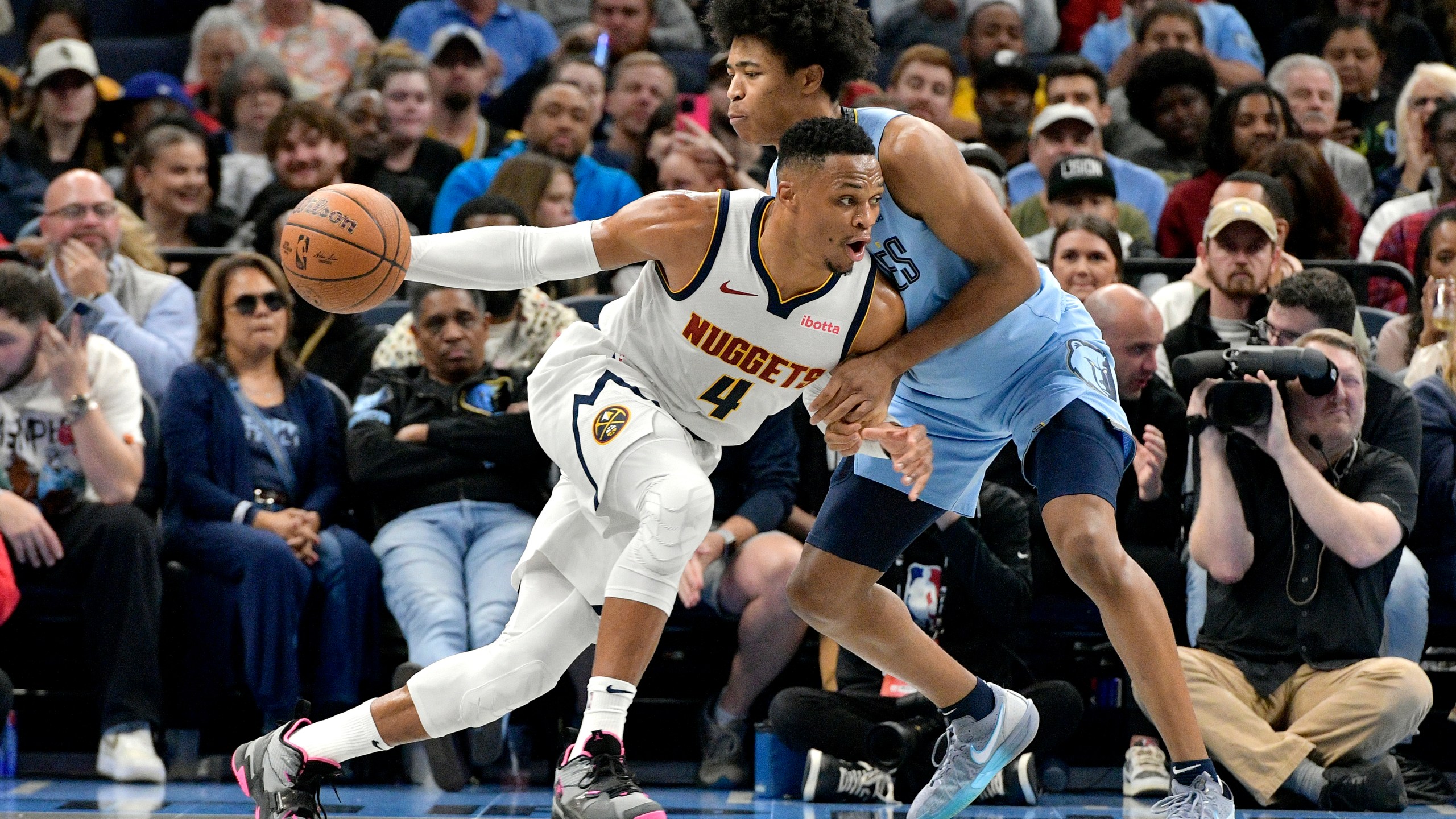 Denver Nuggets guard Russell Westbrook (4) drives against Memphis Grizzlies forward Jaylen Wells in the first half of an Emirates NBA Cup basketball game Tuesday, Nov. 19, 2024, in Memphis, Tenn. (AP Photo/Brandon Dill)