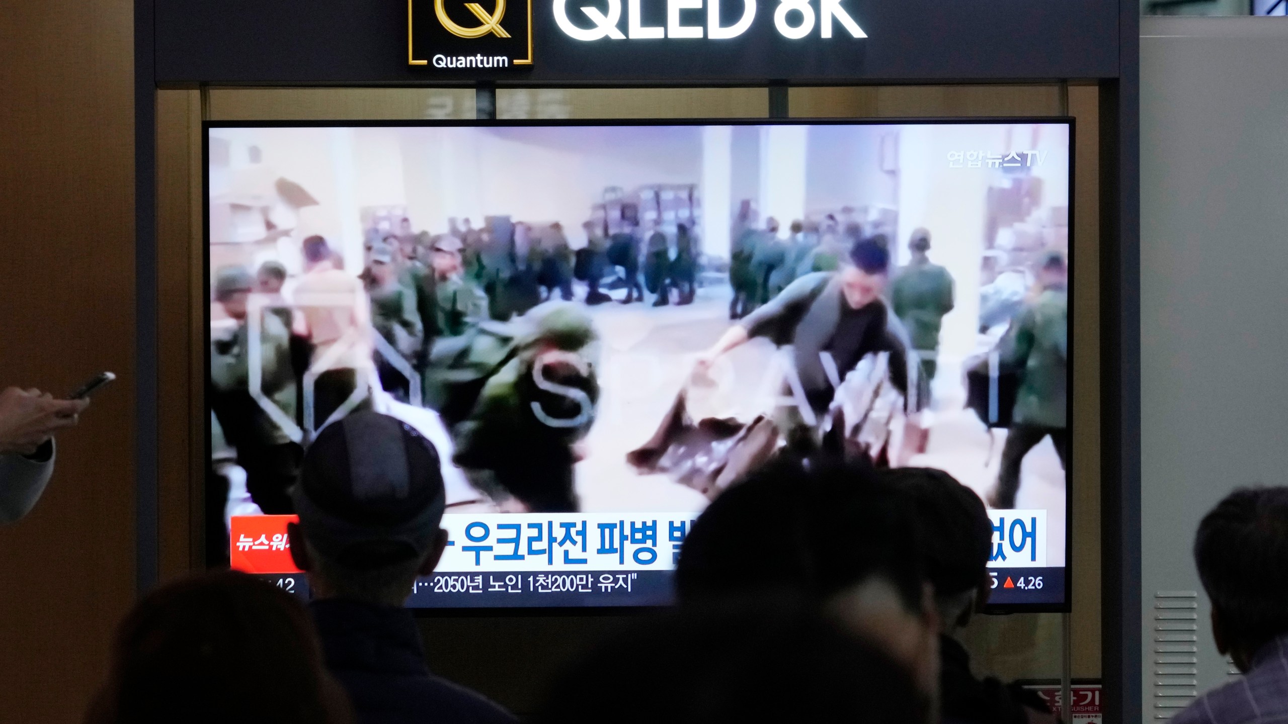 FILE - A TV screen shows an image of soldiers believed to be from North Korea stand in line to receive supplies from Russia during a news program at Seoul Railway Station in Seoul, South Korea, on Oct. 21, 2024. (AP Photo/Ahn Young-joon, File)