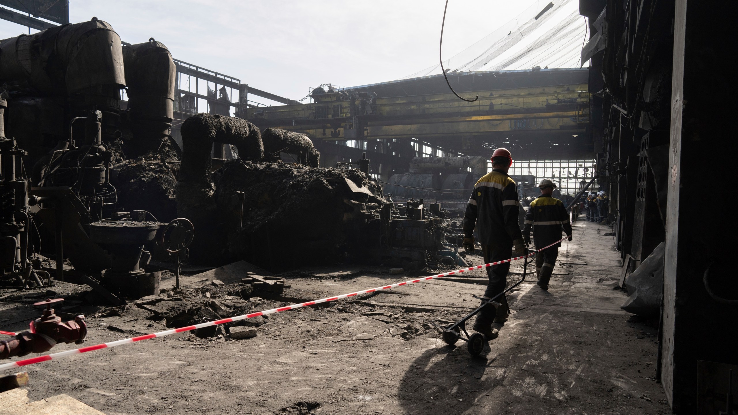 FILE - Workers walk inside DTEK's power plant which was destroyed by a Russian missile attack in Ukraine, April 2, 2024. (AP Photo/Evgeniy Maloletka, File)