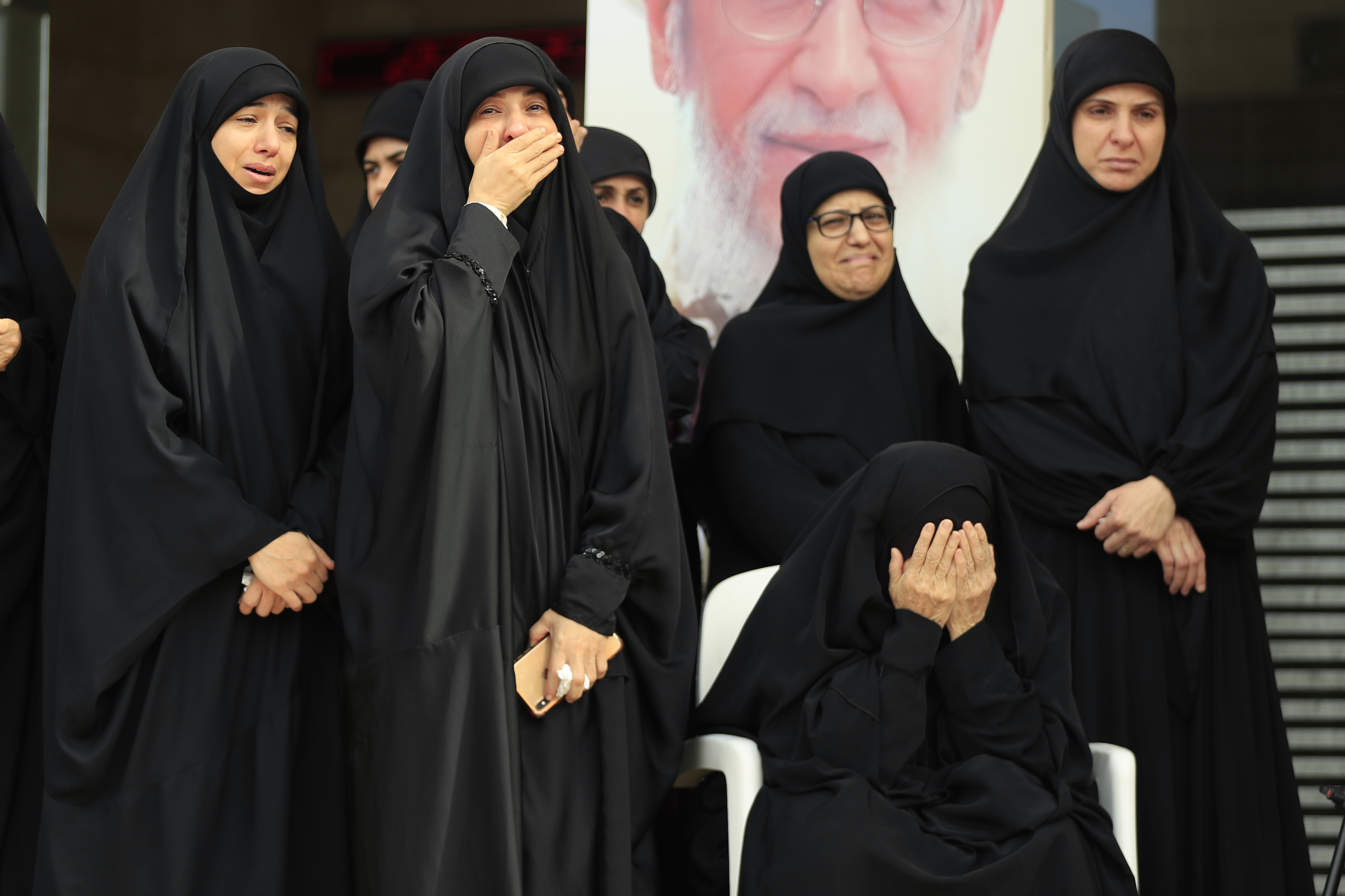 Relatives of Hezbollah's chief spokesman Mohammed Afif who was killed in an Israeli airstrike in Beirut on Sunday, mourn during his funeral in the southern port city of Sidon, Lebanon, Monday, Nov. 18, 2024. (AP Photo/Mohammed Zaatari)