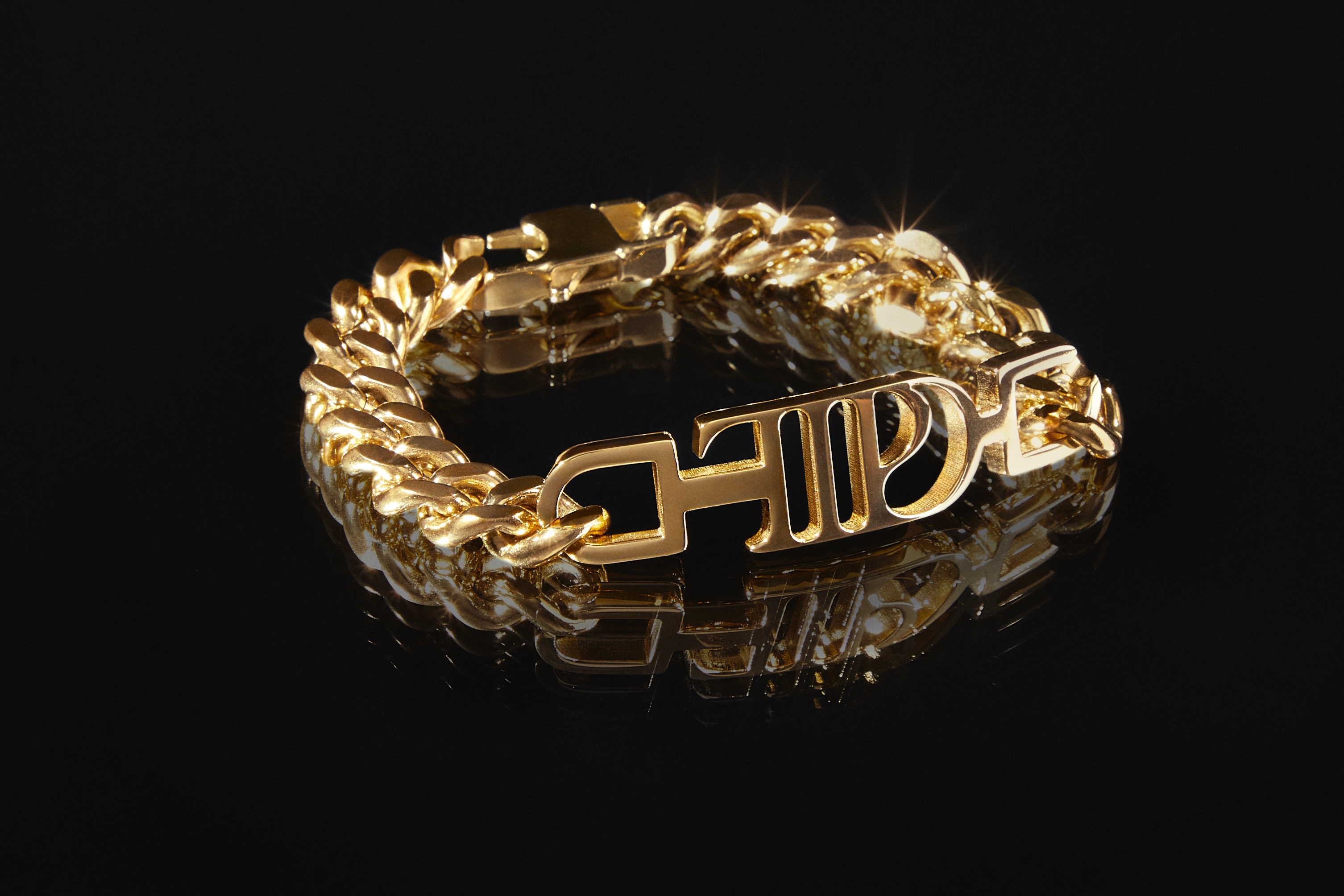 This image shows a gold-plated chain link bracelet, featuring the logo for Taylor Swift's album, "The Tortured Poets Department." (TAS Rights Management via AP)