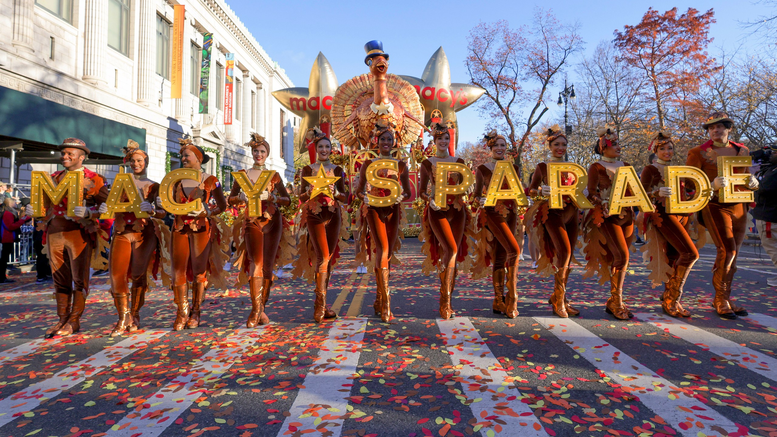 FILE - Parade performers lead the Tom Turkey float down Central Park West at the start of the Macy's Thanksgiving Day parade on Nov. 23, 2023, in New York. (AP Photo/Jeenah Moon, File)