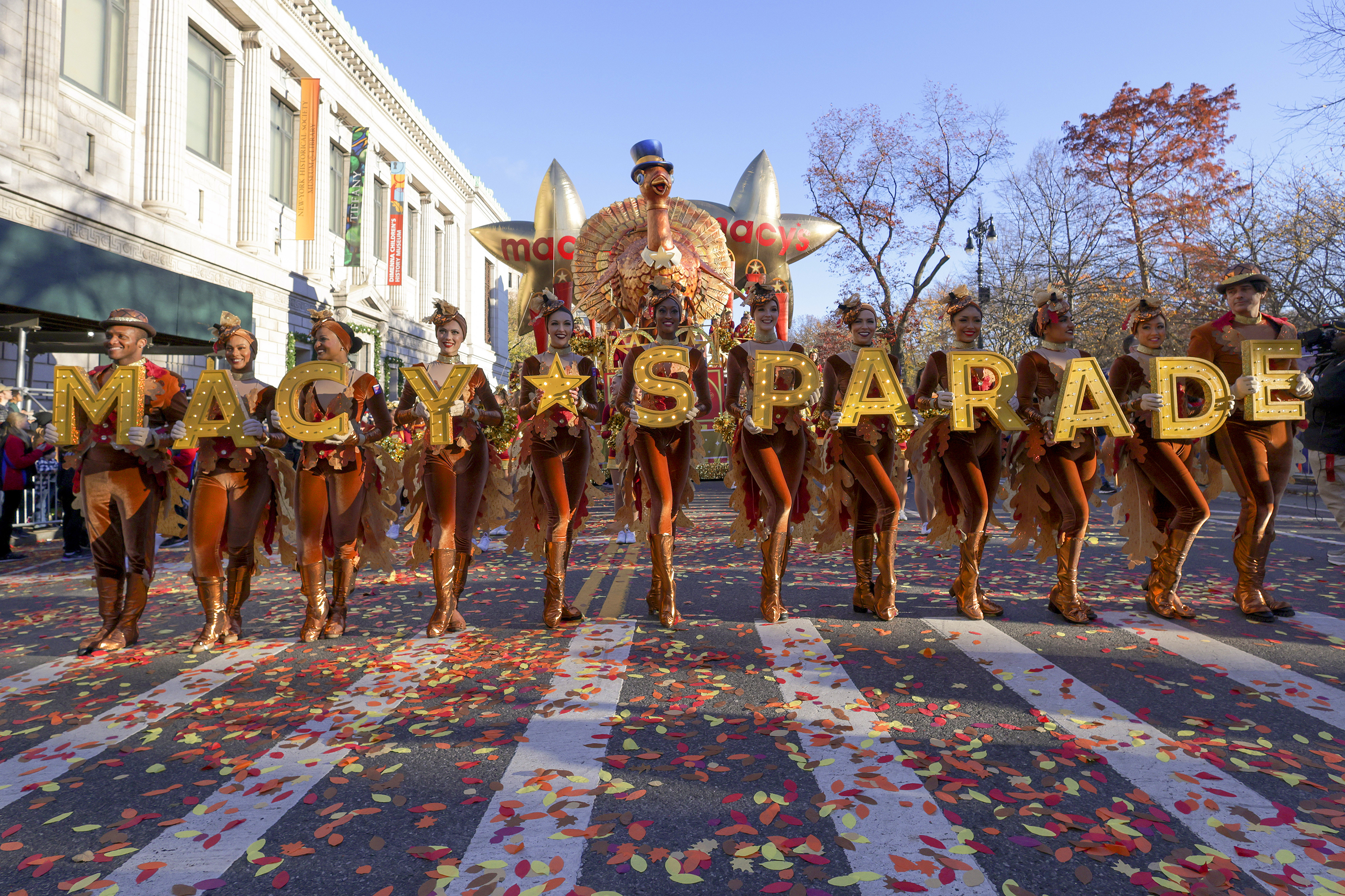 FILE - Parade performers lead the Tom Turkey float down Central Park West at the start of the Macy's Thanksgiving Day parade on Nov. 23, 2023, in New York. (AP Photo/Jeenah Moon, File)