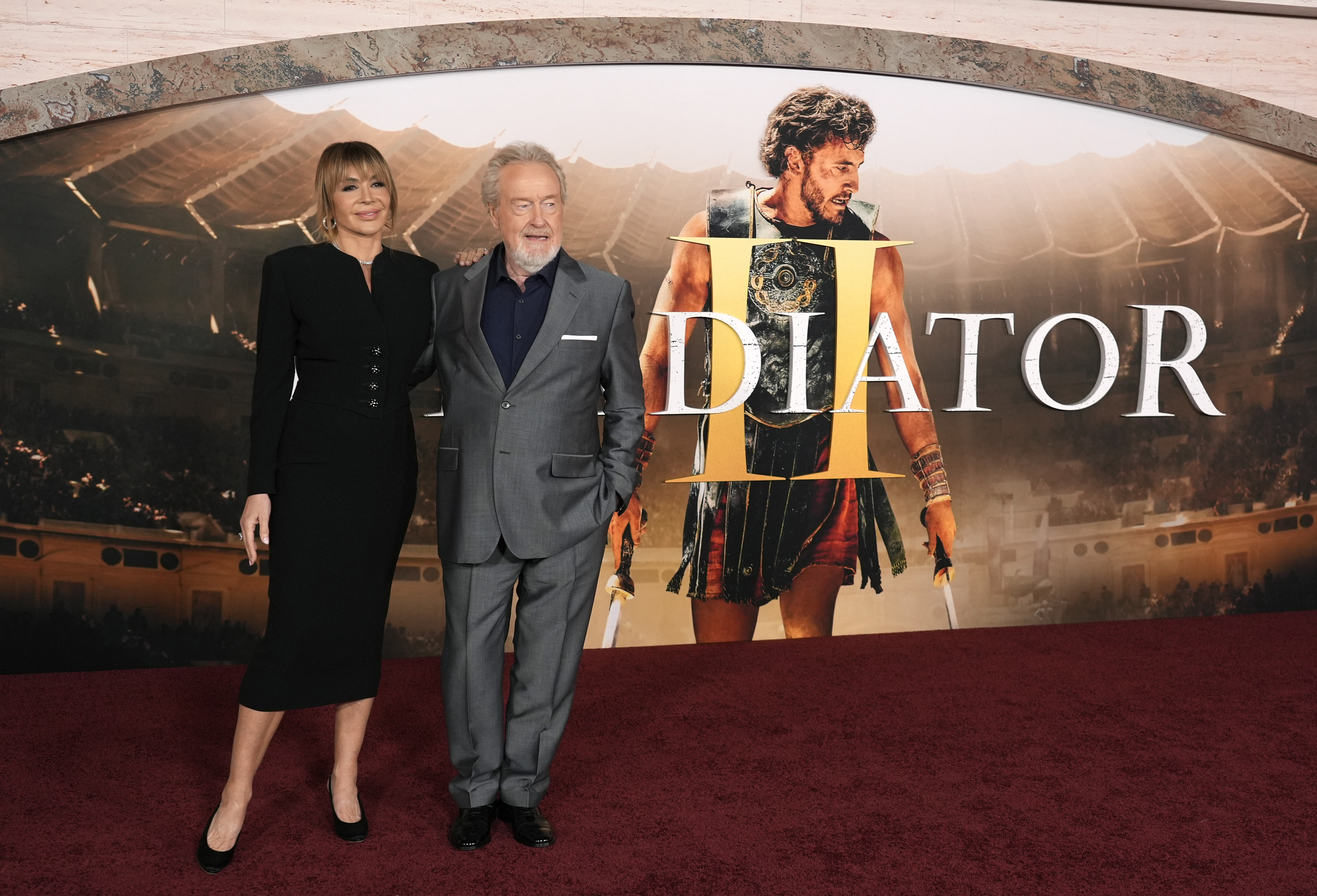 Ridley Scott, right, director of "Gladiator II," poses with his wife Giannina Facio at the premiere of the film on Monday, Nov. 18, 2024, at TCL Chinese Theatre in Los Angeles. (AP Photo/Chris Pizzello)