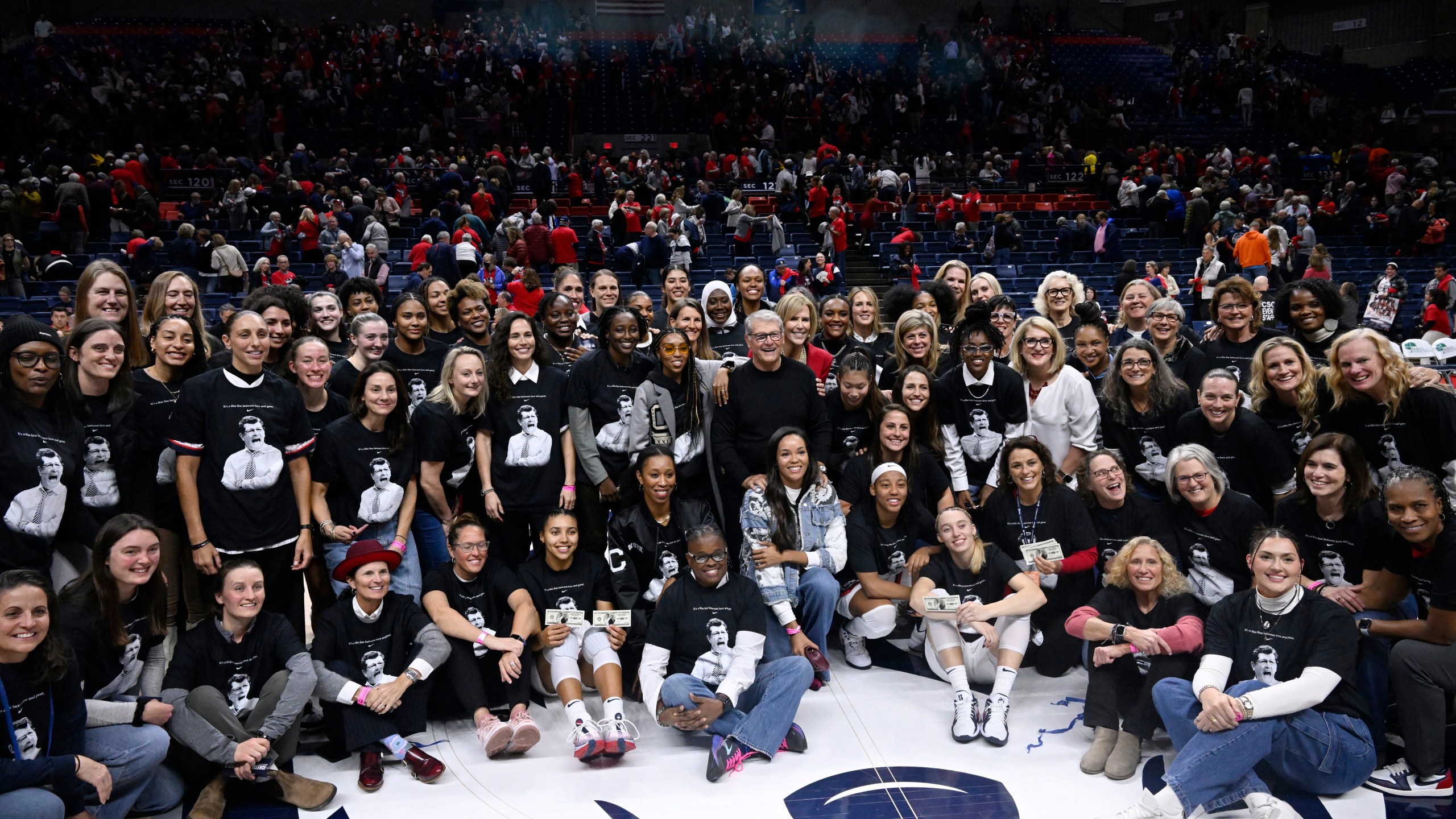 UConn head coach Geno Auriemma poses for a photograph with his players past and present and coaches as he is honored for the most wins in college basketball history, Wednesday, Nov. 20, 2024, in Storrs, Conn. (AP Photo/Jessica Hill)