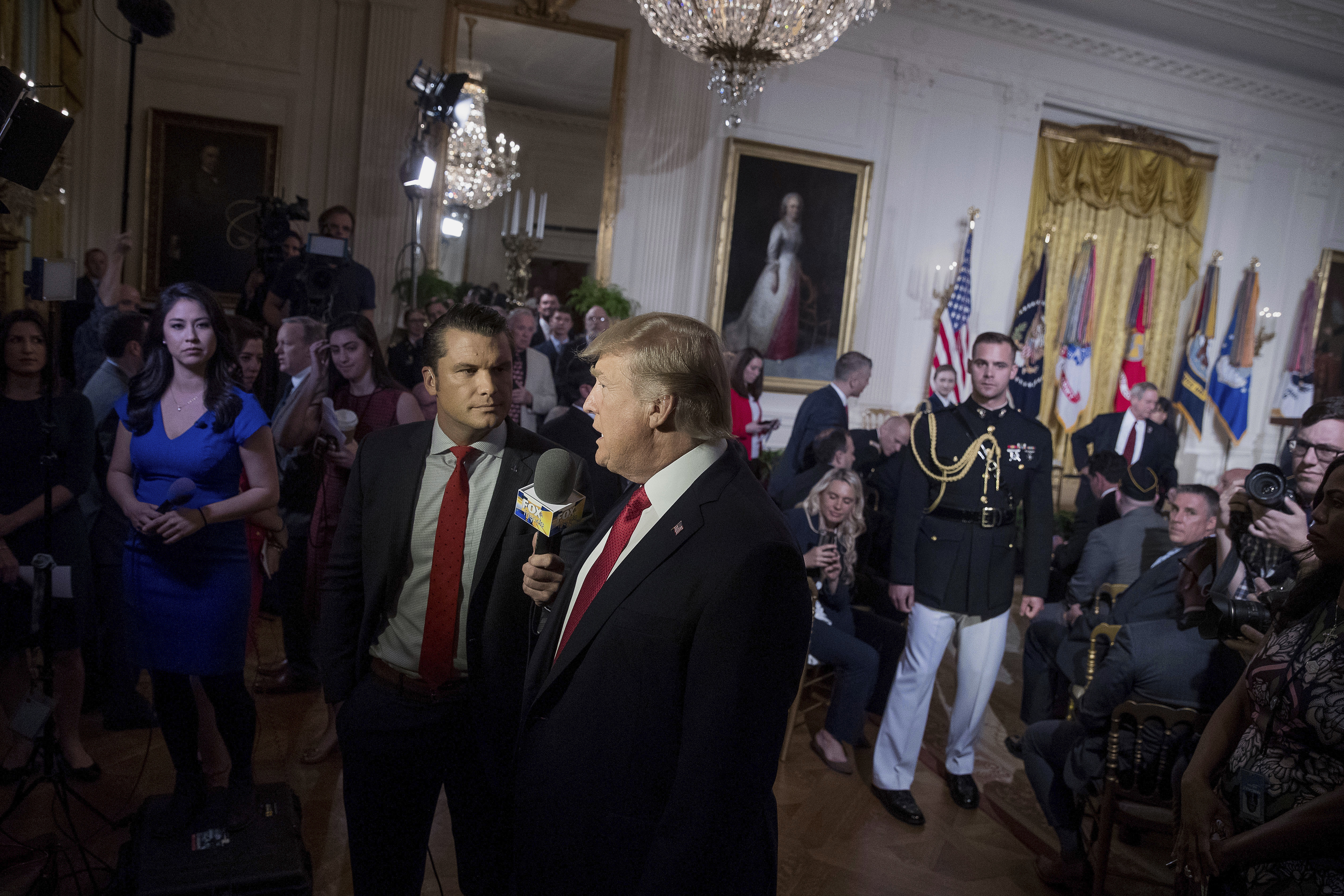 FILE - President Donald Trump appears on Fox & Friends co-host Pete Hegseth at a Wounded Warrior Project Soldier Ride event in the East Room of the White House in Washington, Thursday, April 6, 2017. (AP Photo/Andrew Harnik, File)