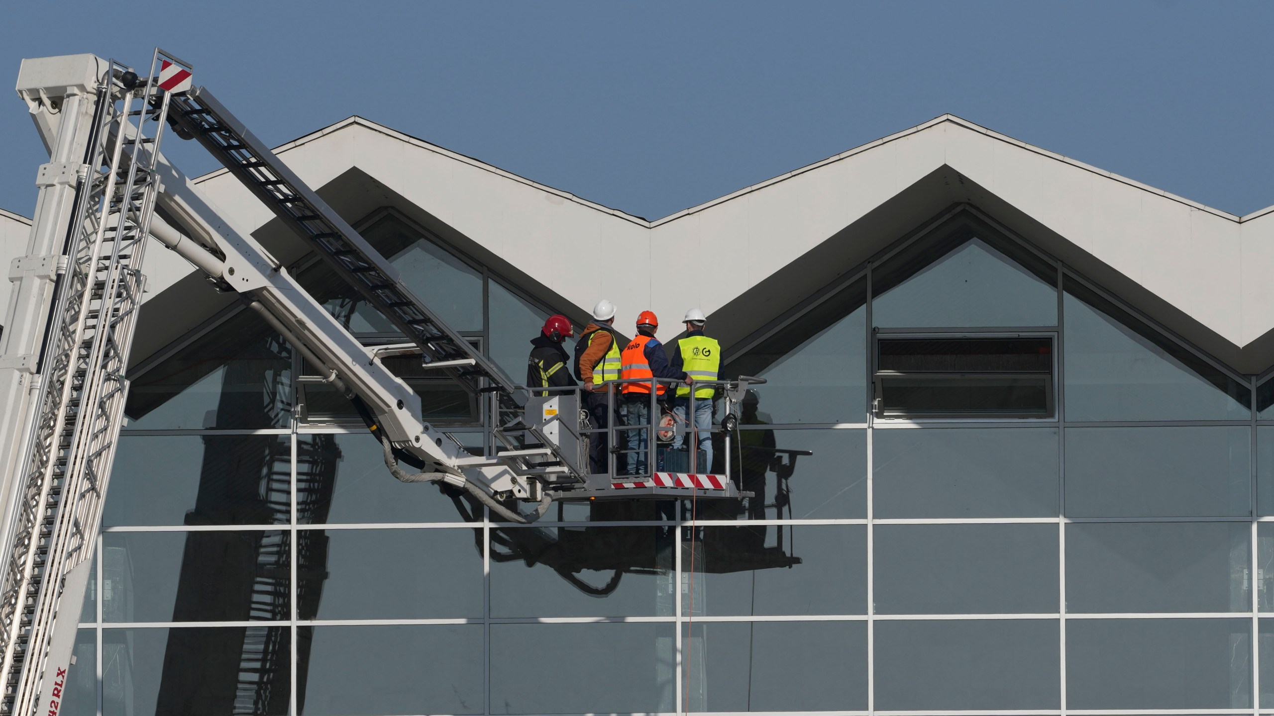 Workers inspect a train station after an outdoor roof collapsed in Novi Sad, Serbia, Saturday, Nov. 2, 2024. (AP Photo/Darko Vojinovic)