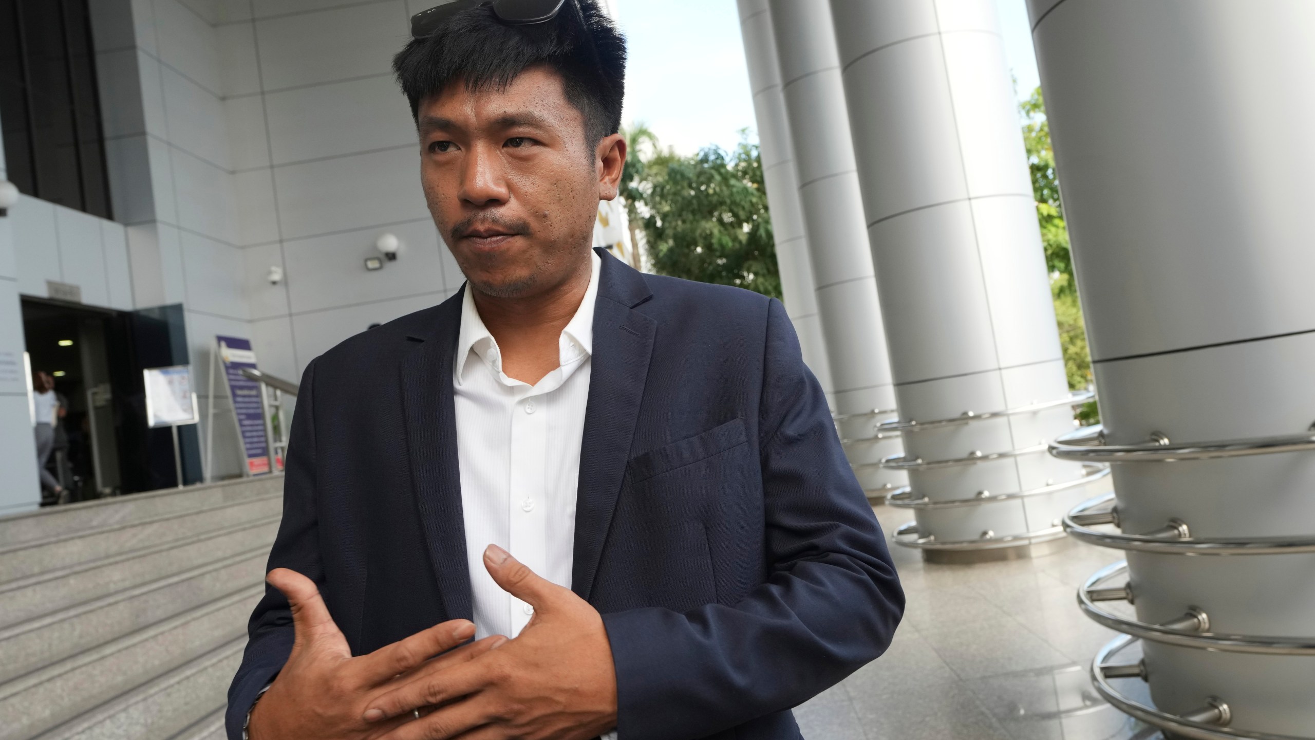 Jatupat Boonpattararaksa talks to reporters before leaving the Civil Court in Bangkok, Thailand, Thursday, Nov. 21, 2024. (AP Photo/Sakchai Lalit)