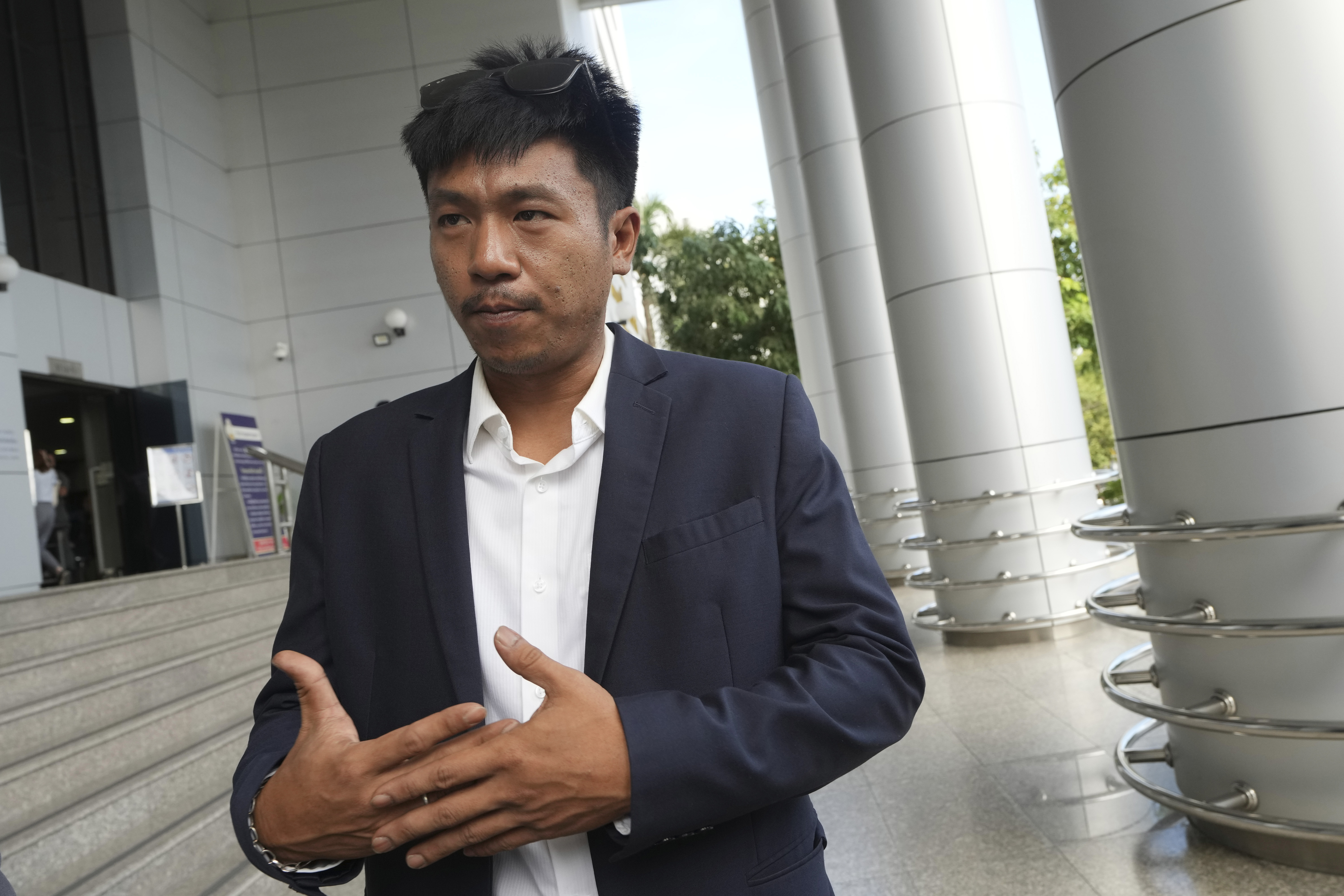 Jatupat Boonpattararaksa talks to reporters before leaving the Civil Court in Bangkok, Thailand, Thursday, Nov. 21, 2024. (AP Photo/Sakchai Lalit)